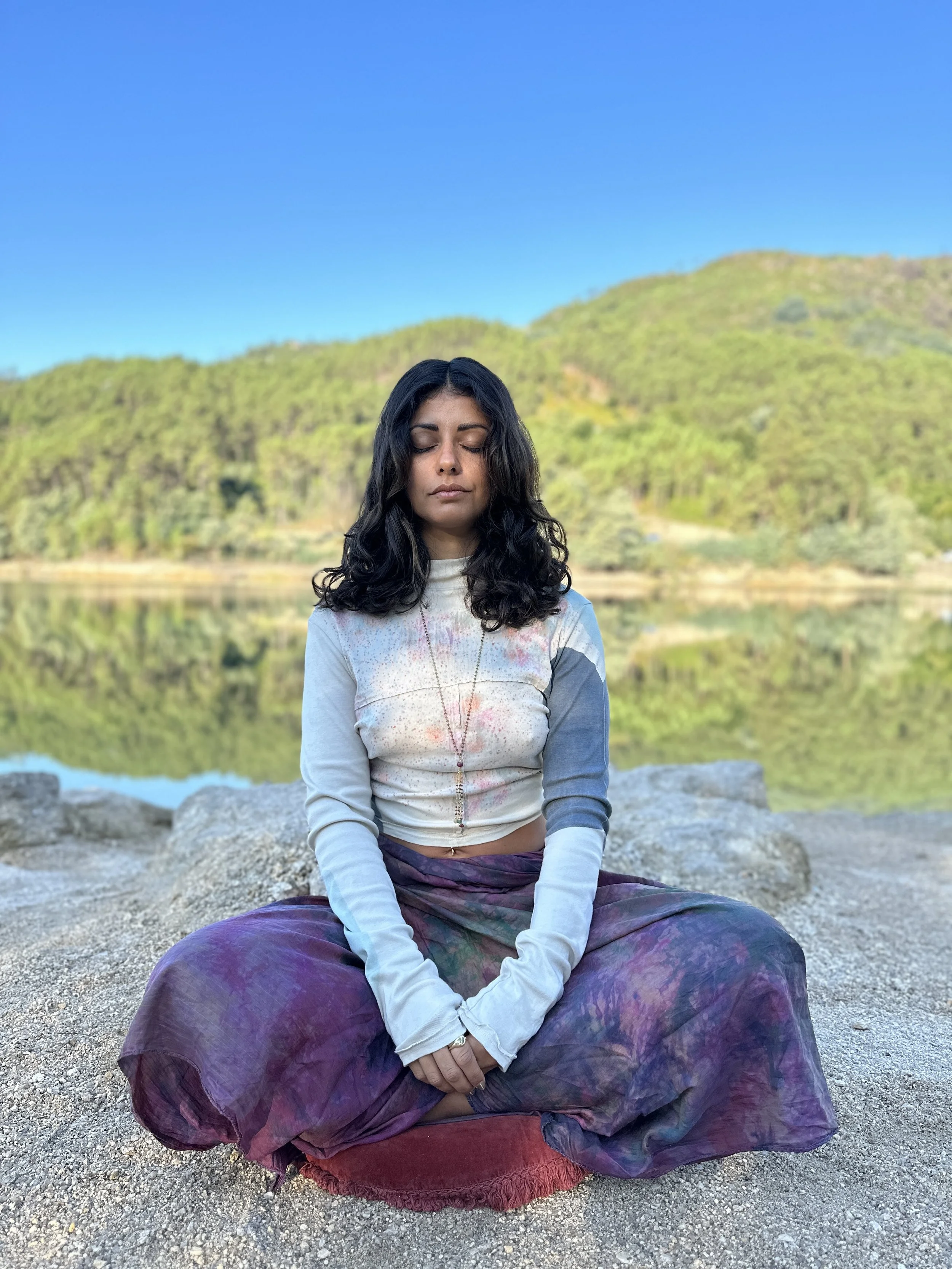 Natalie meditating by the water
