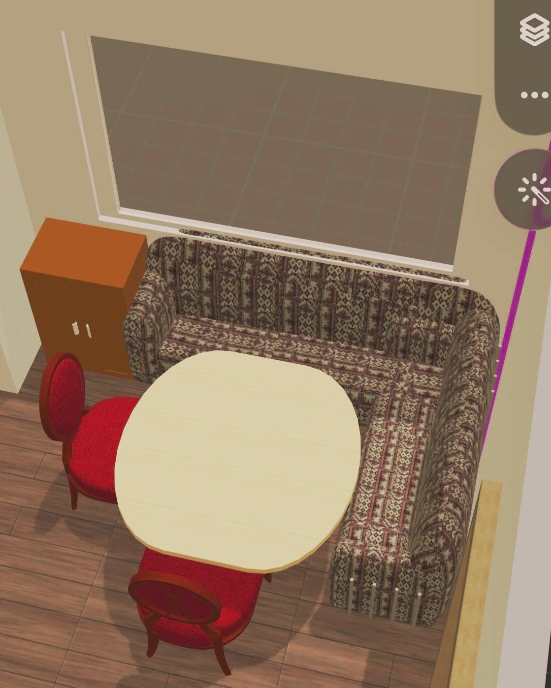 A cozy dining nook with a U-shaped patterned sofa, a cream oval table, red upholstered chairs, a wooden cabinet, a window, and floor lamp in a room with wooden flooring.