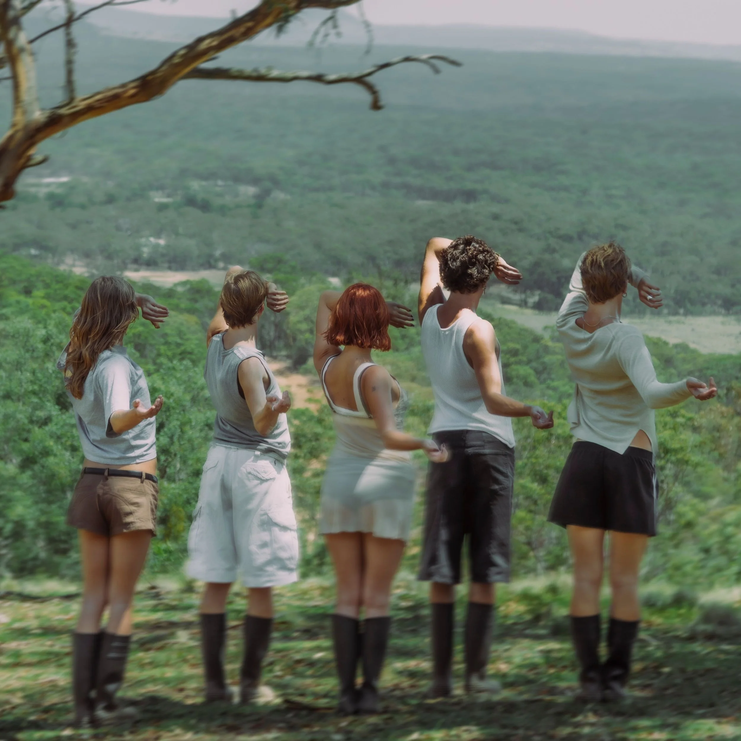 Cover art for Salty's single 'Touch Grass', showing five people from behind in an outdoor landscape, mirroring a dance pose against a lush green valley.