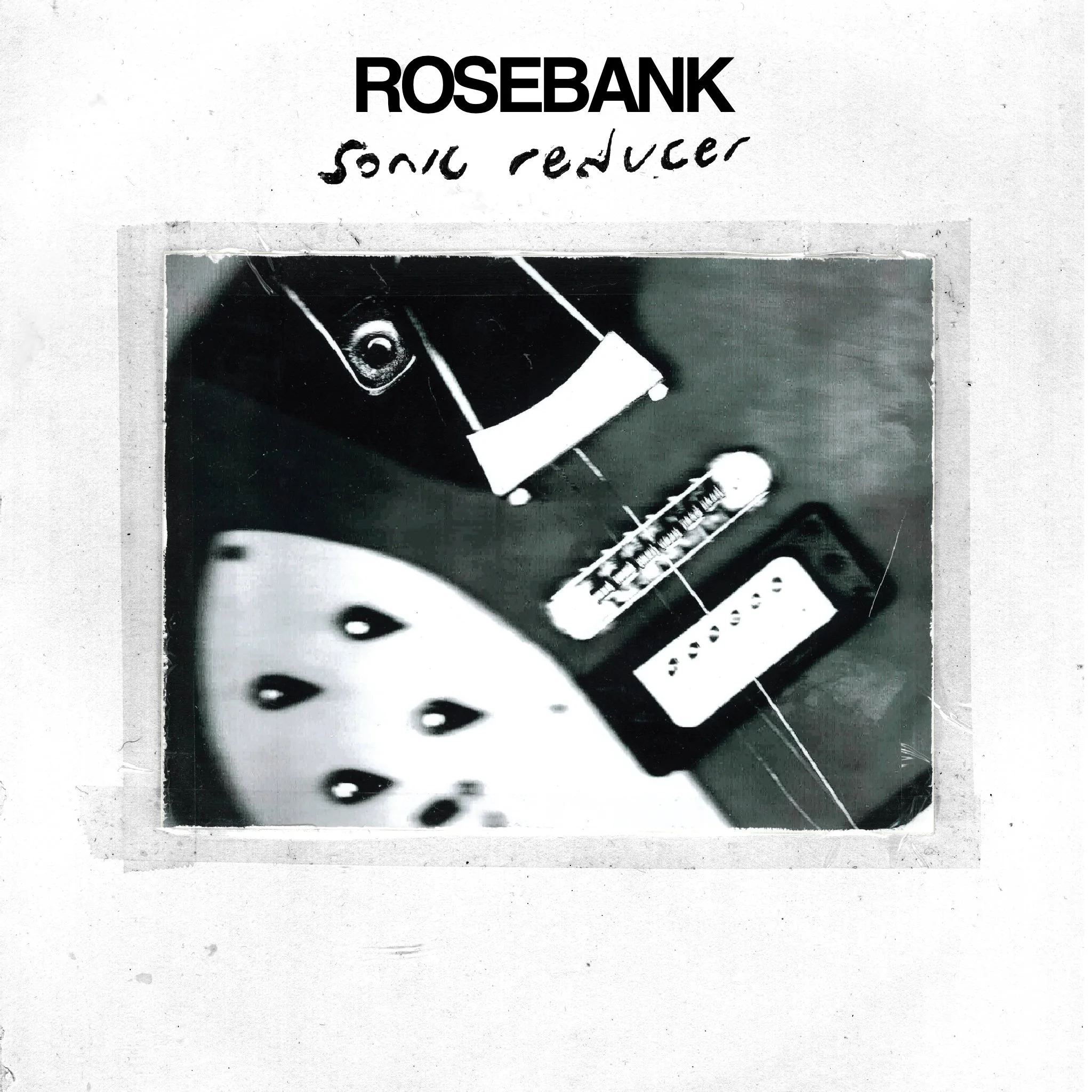 Sonic Reducer Rosebank single cover: A grainy, black and white Polaroid-style close-up photo of an electric guitar body on a textured white border.