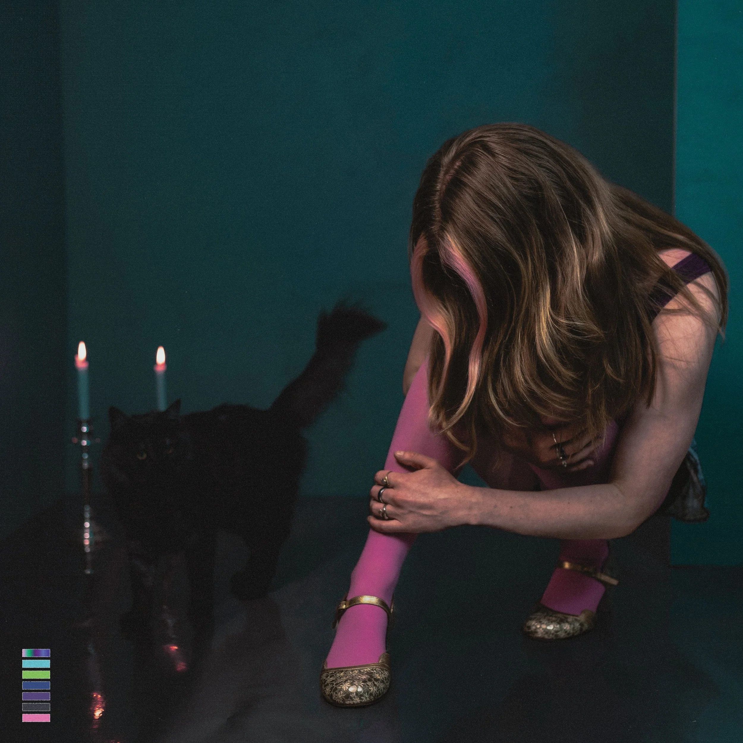 Holly Hebe Mood Ring EP cover: Close-up of Holly Hebe with pink-streaked hair, wearing a purple top and multiple rings against a blue background.