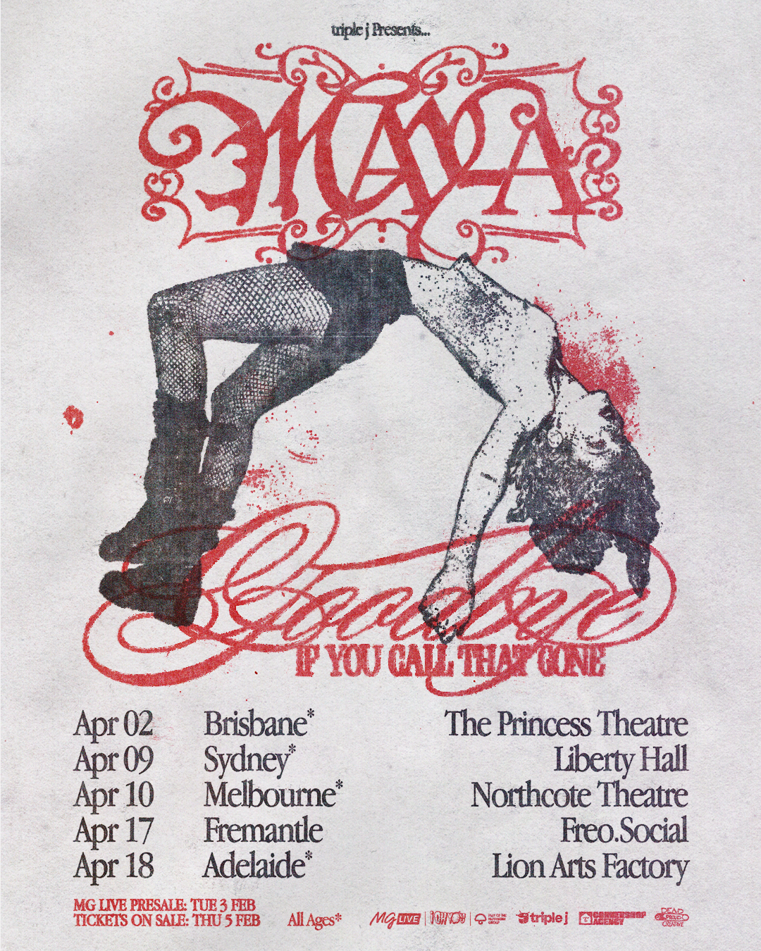 Singer MAY-A stands center stage in a red latex jacket, flanked by her band and bright spotlights. Photo by Ruby Boland.