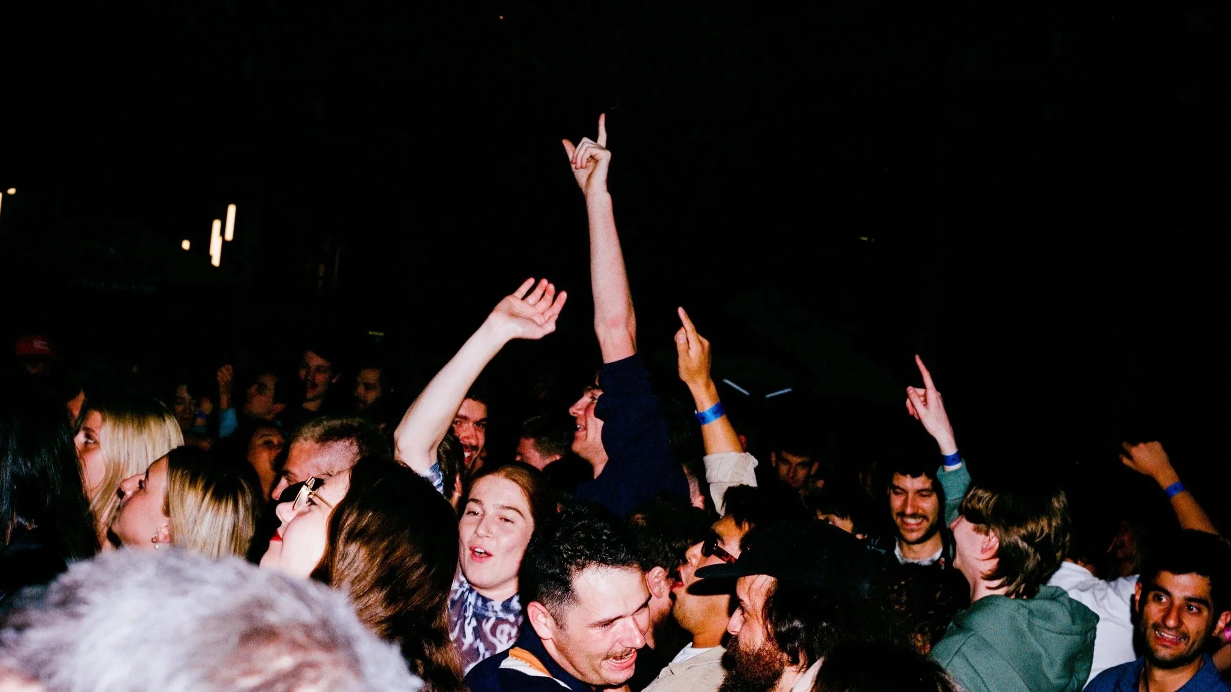 Atmospheric wide shot of a crowded concert at Hindley Street Music Hall in Adelaide, featuring a large chandelier and golden stage lighting.