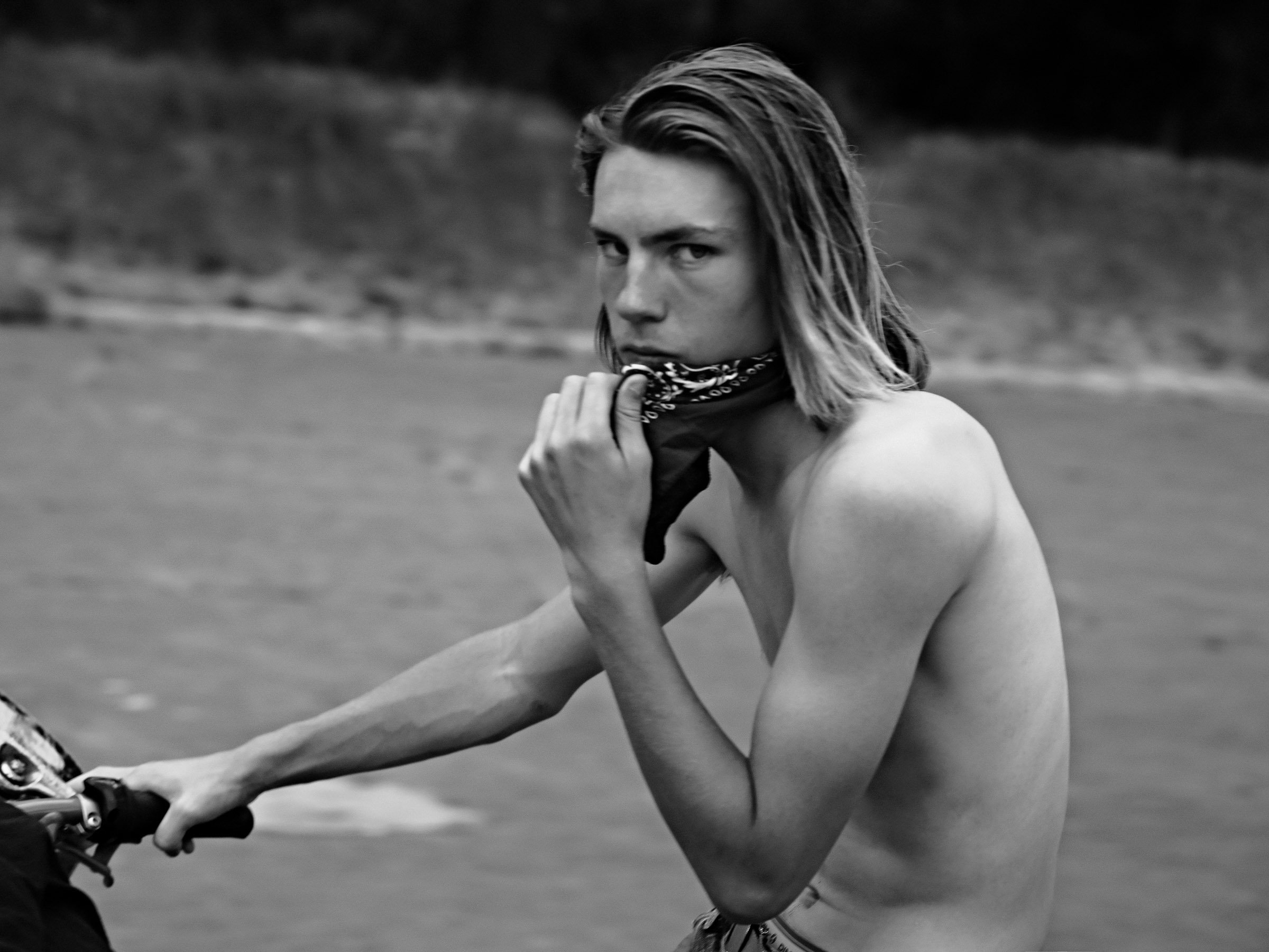 Black and white photograph of a young male body exposed in urban space, from the series FRICTION by Lulu La Falaise.