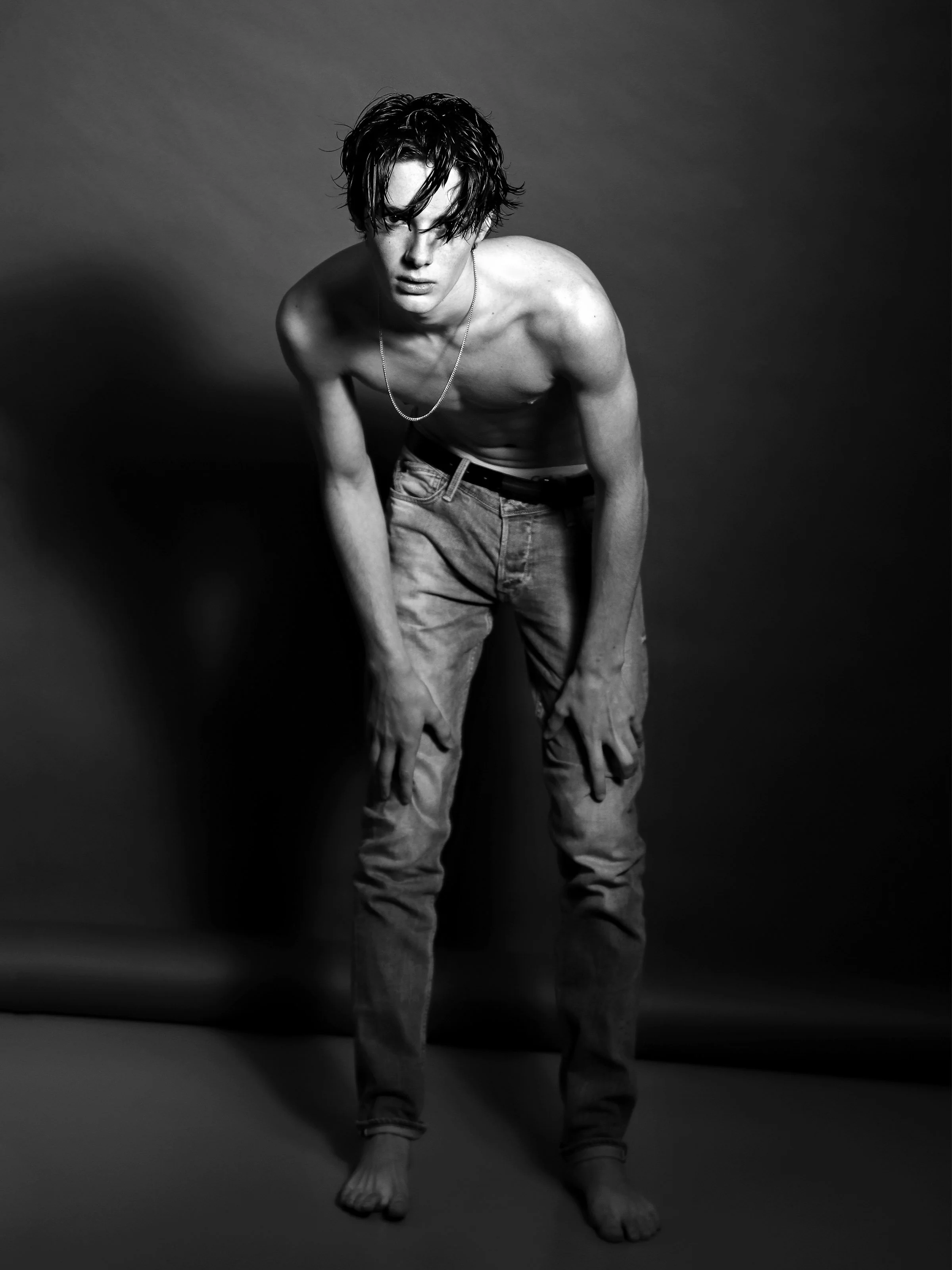 Black and white photograph of a young male body exposed in urban space, from the series FRICTION by Lulu La Falaise.