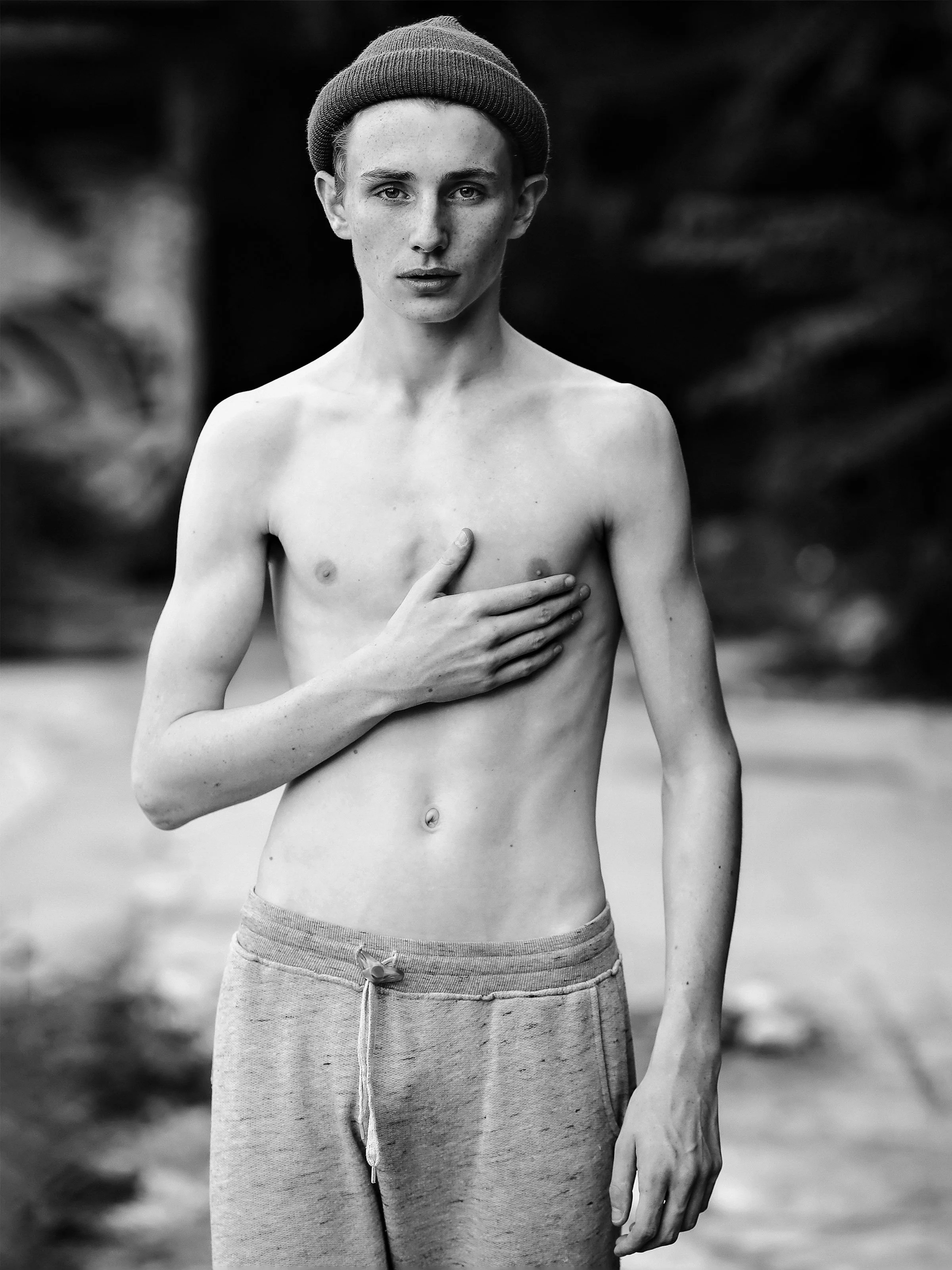 Black and white photograph of a young male body exposed in urban space, from the series FRICTION by Lulu La Falaise.