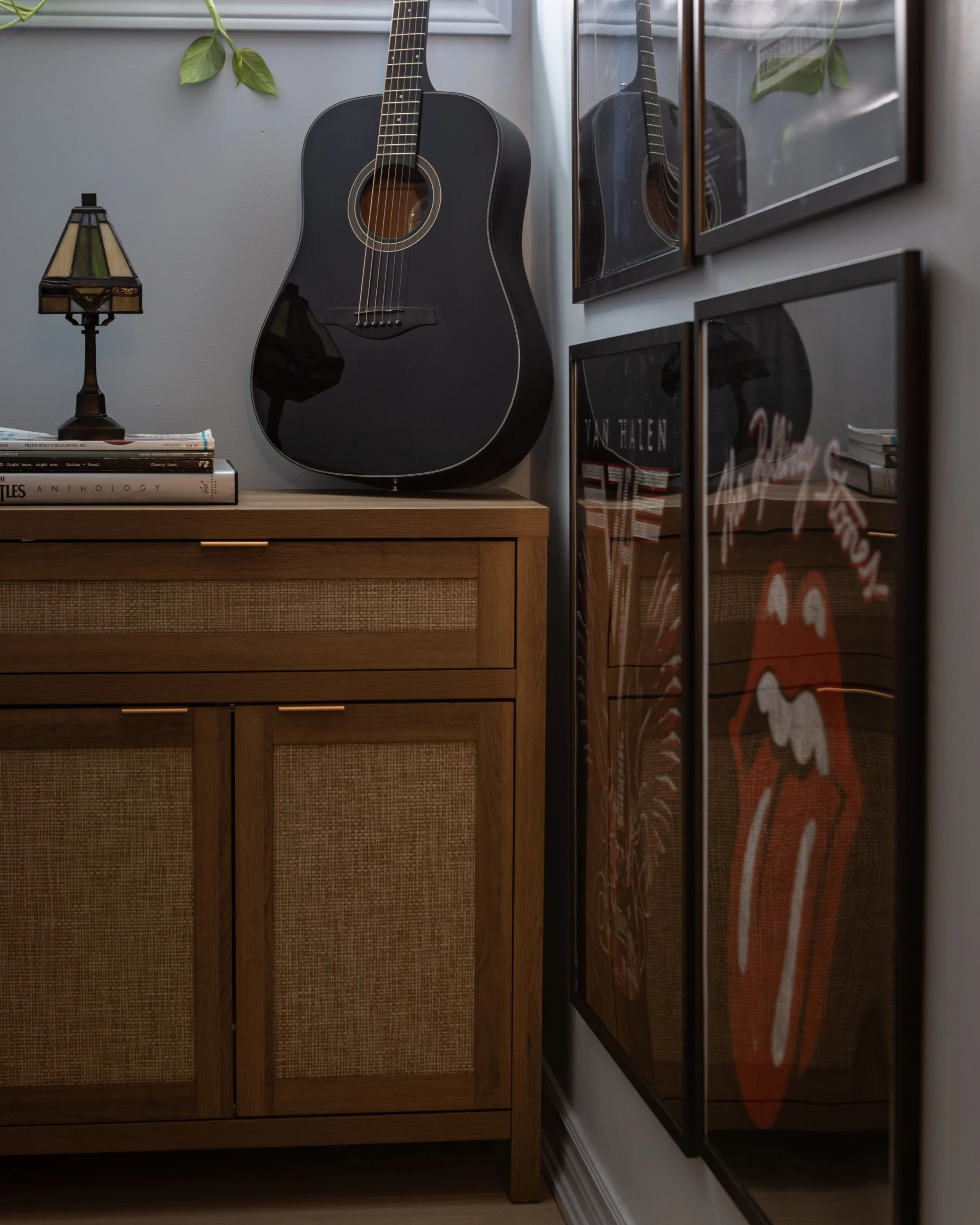 Guitar displayed against music poster wall in Toronto Ontario, Project Ten Forward by Inspired Spaces Design Studio