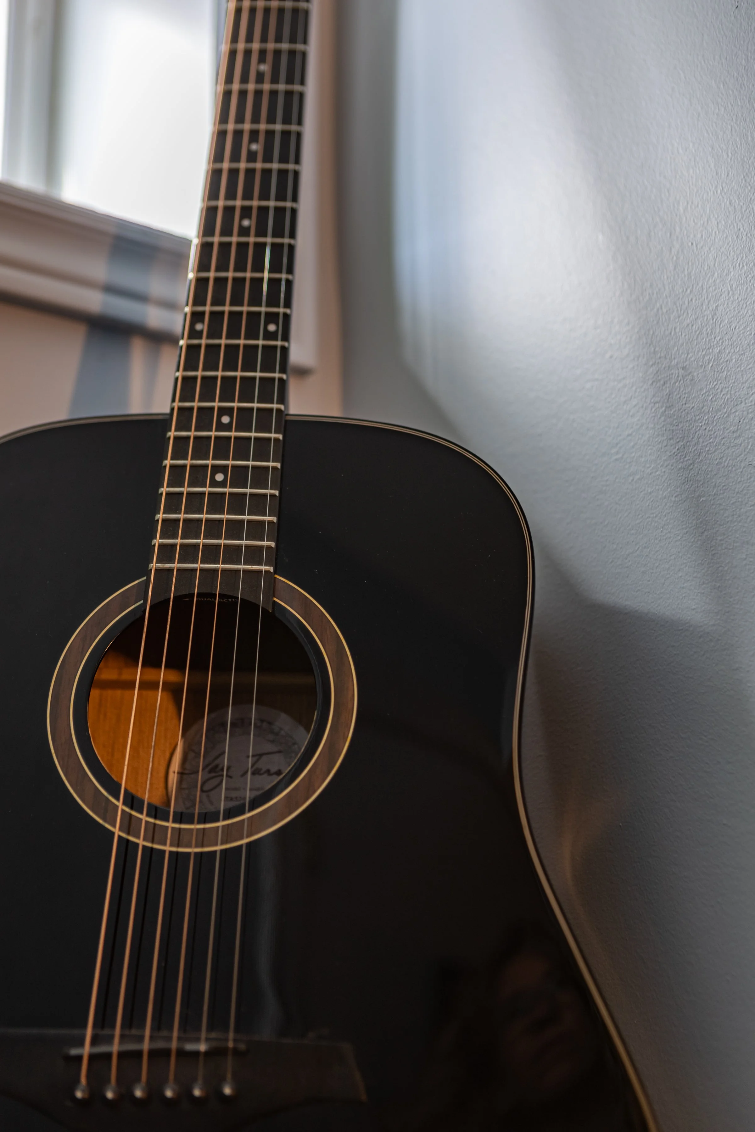 Guitar displayed against music poster wall in Toronto Ontario, Project Ten Forward by Inspired Spaces Design Studio