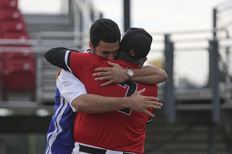 CUa student hugs baseball coach