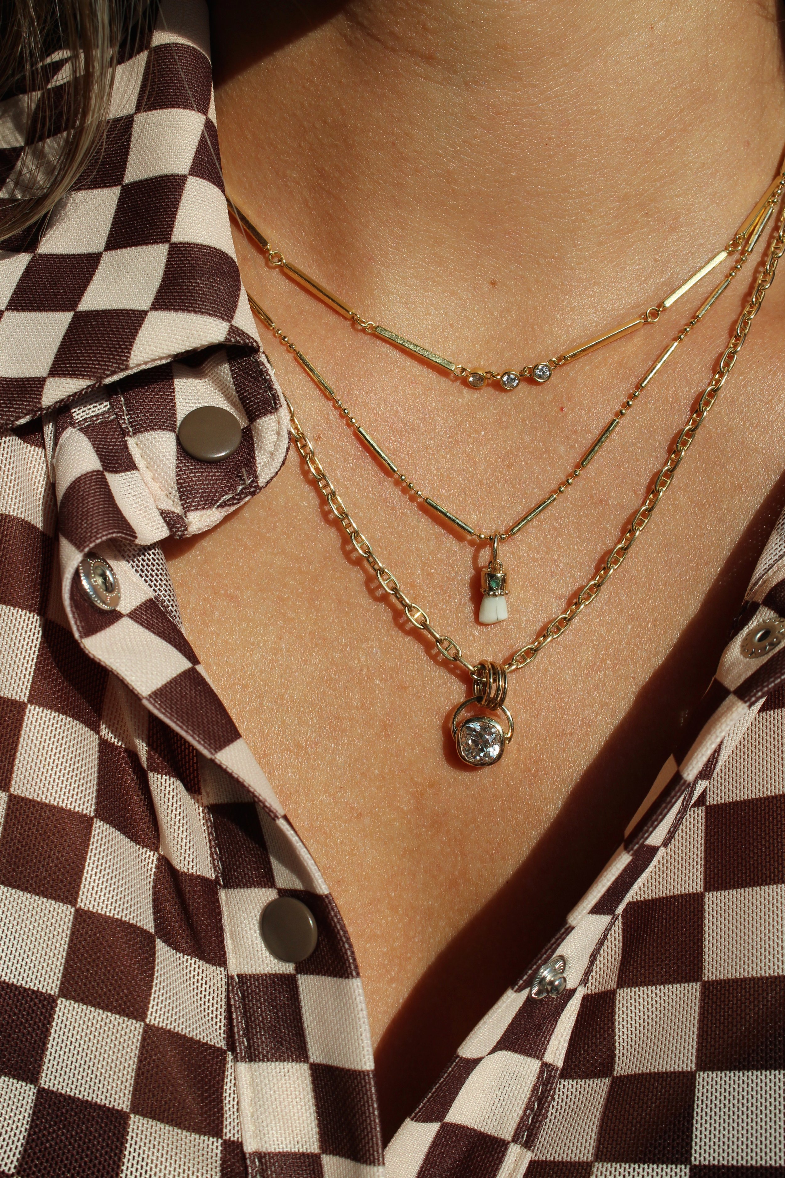 Necklace stack which features the fiddler diamond pendant