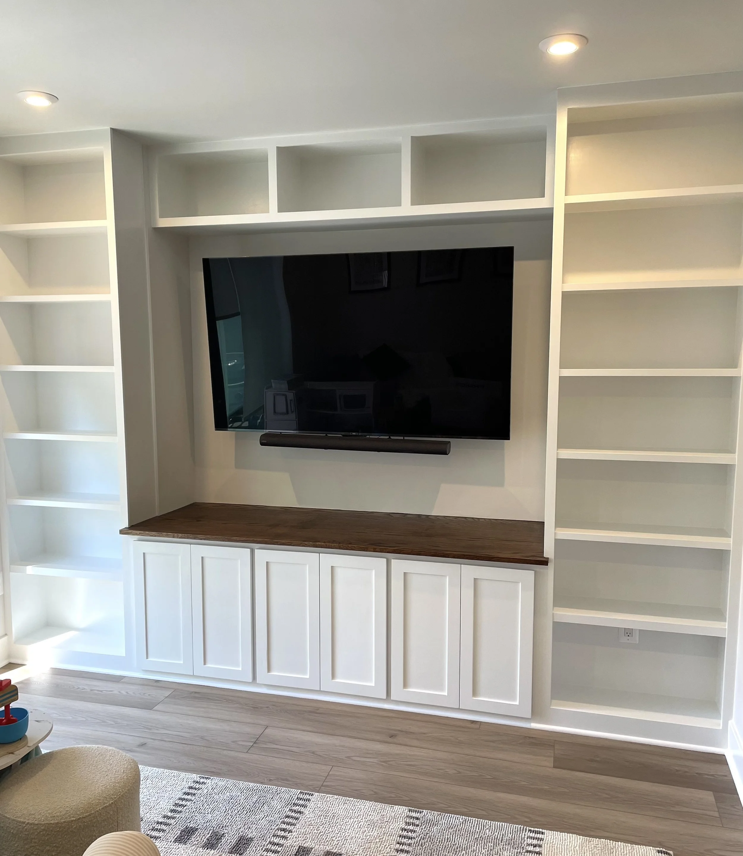 Family room built-in bookcases surrounding TV