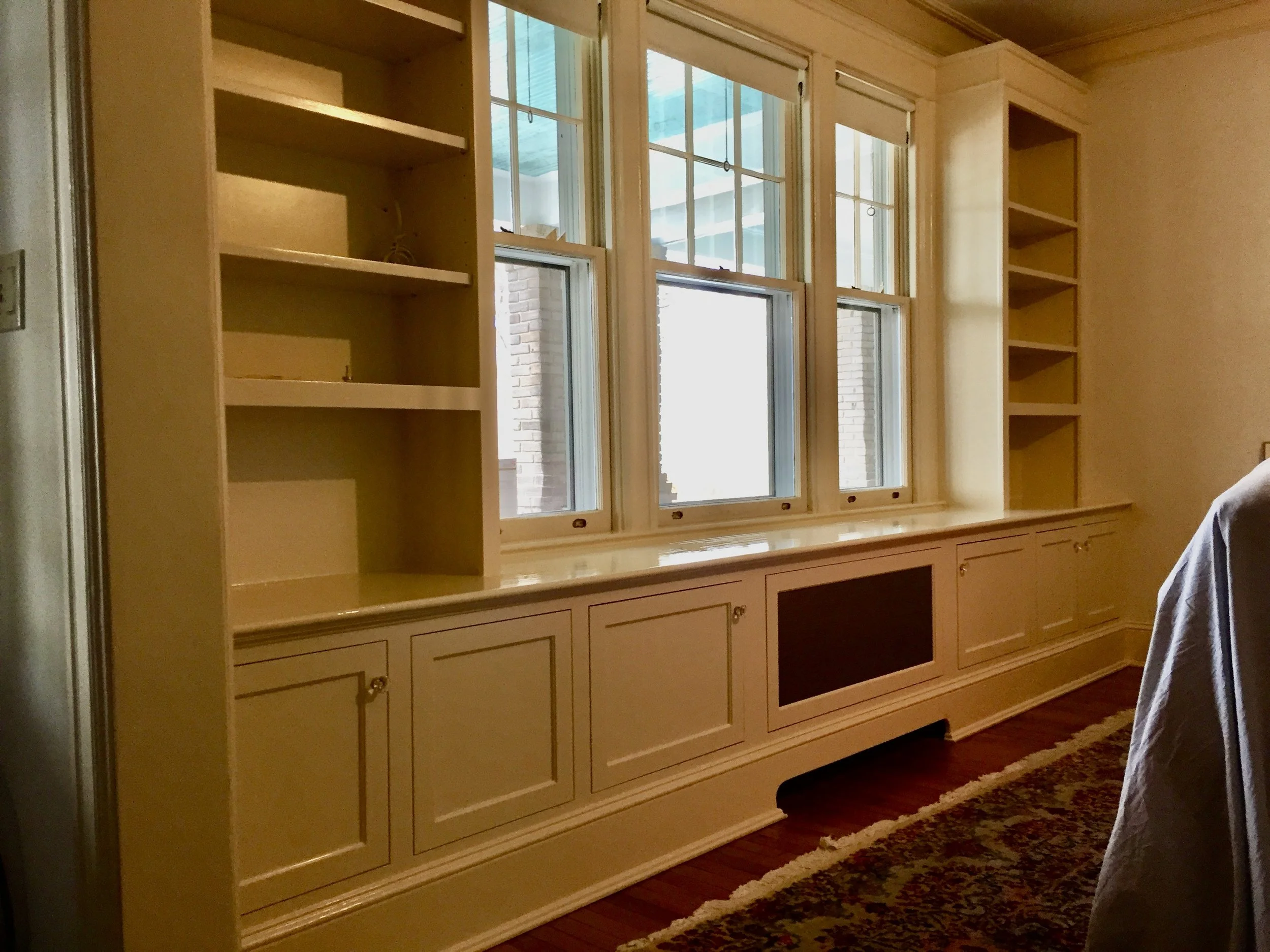 Living room window surround with vented radiator cover
