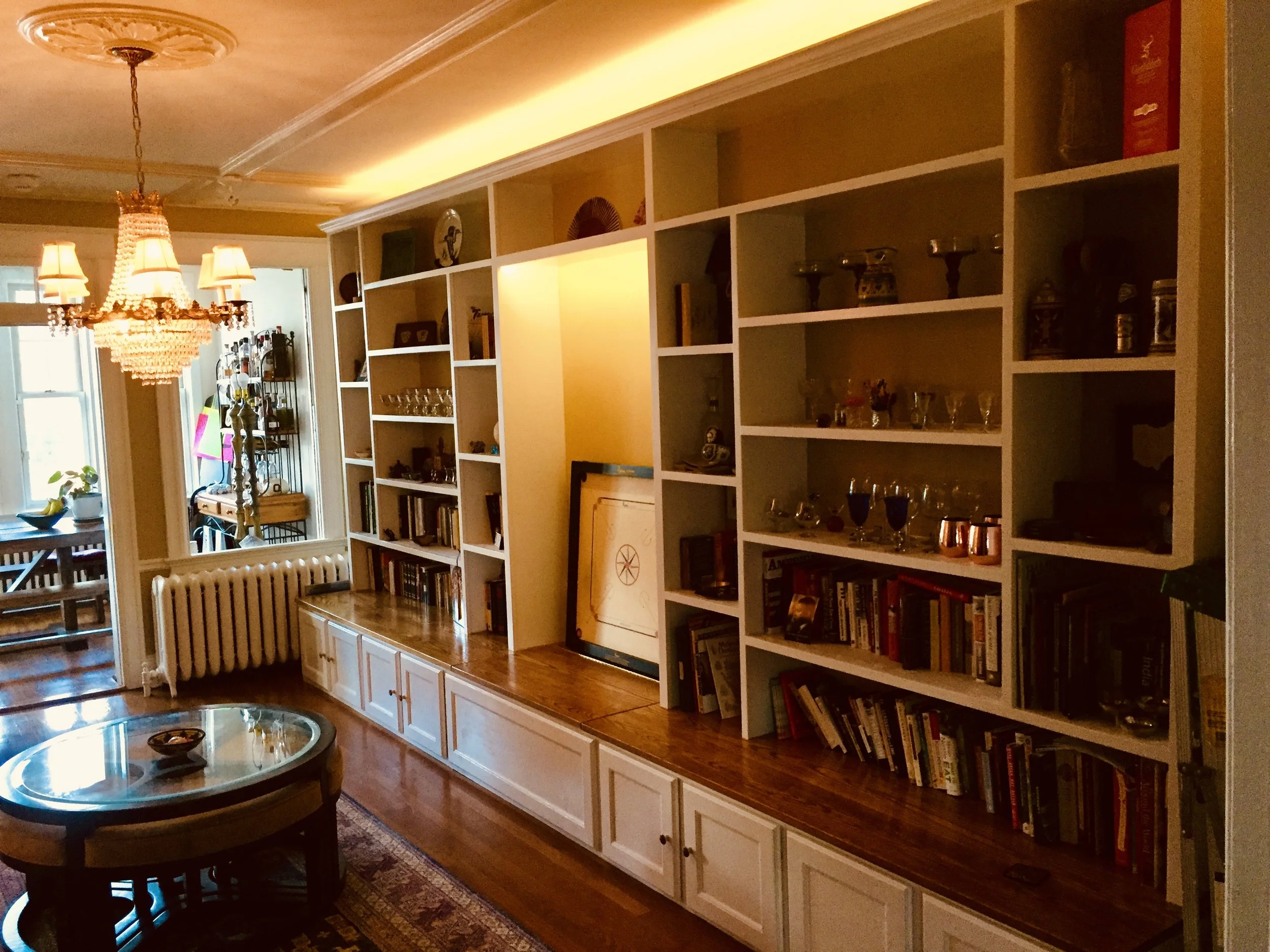 Built-in bookcases with seat-level nook and storage cabinets