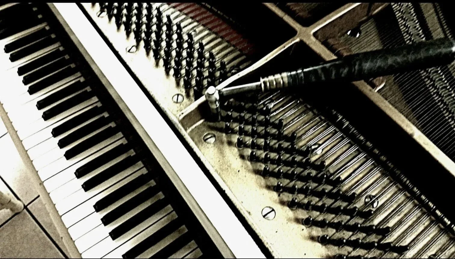 Piano with tuning wrench