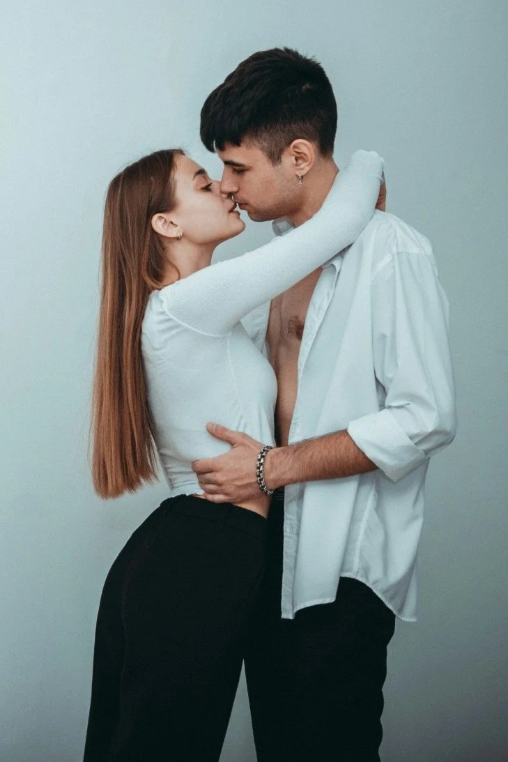 young couple embracing wearing white