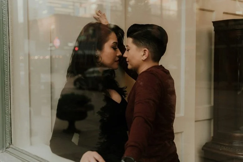 lesbian couple almost kissing