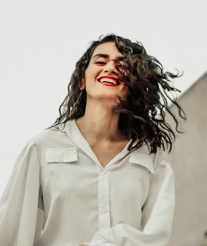 young brunette woman smiles at camera