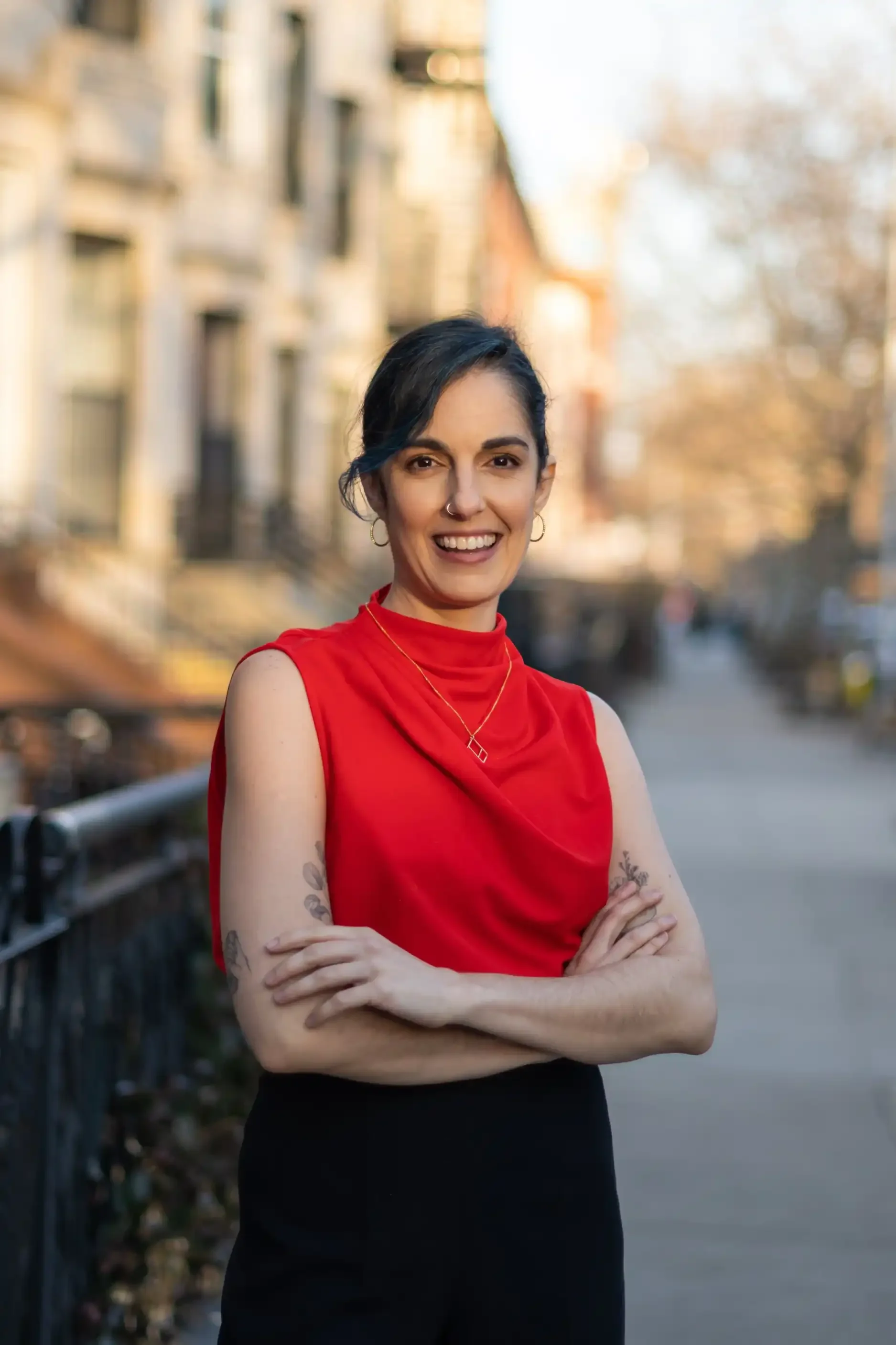 Claudia Giolitti-Wright Founder of Psychotherapy for young women smiling at camera in red top