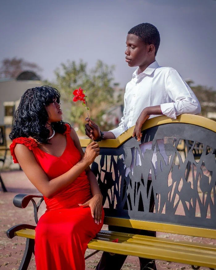 young couple in elegant clothes looking at each other