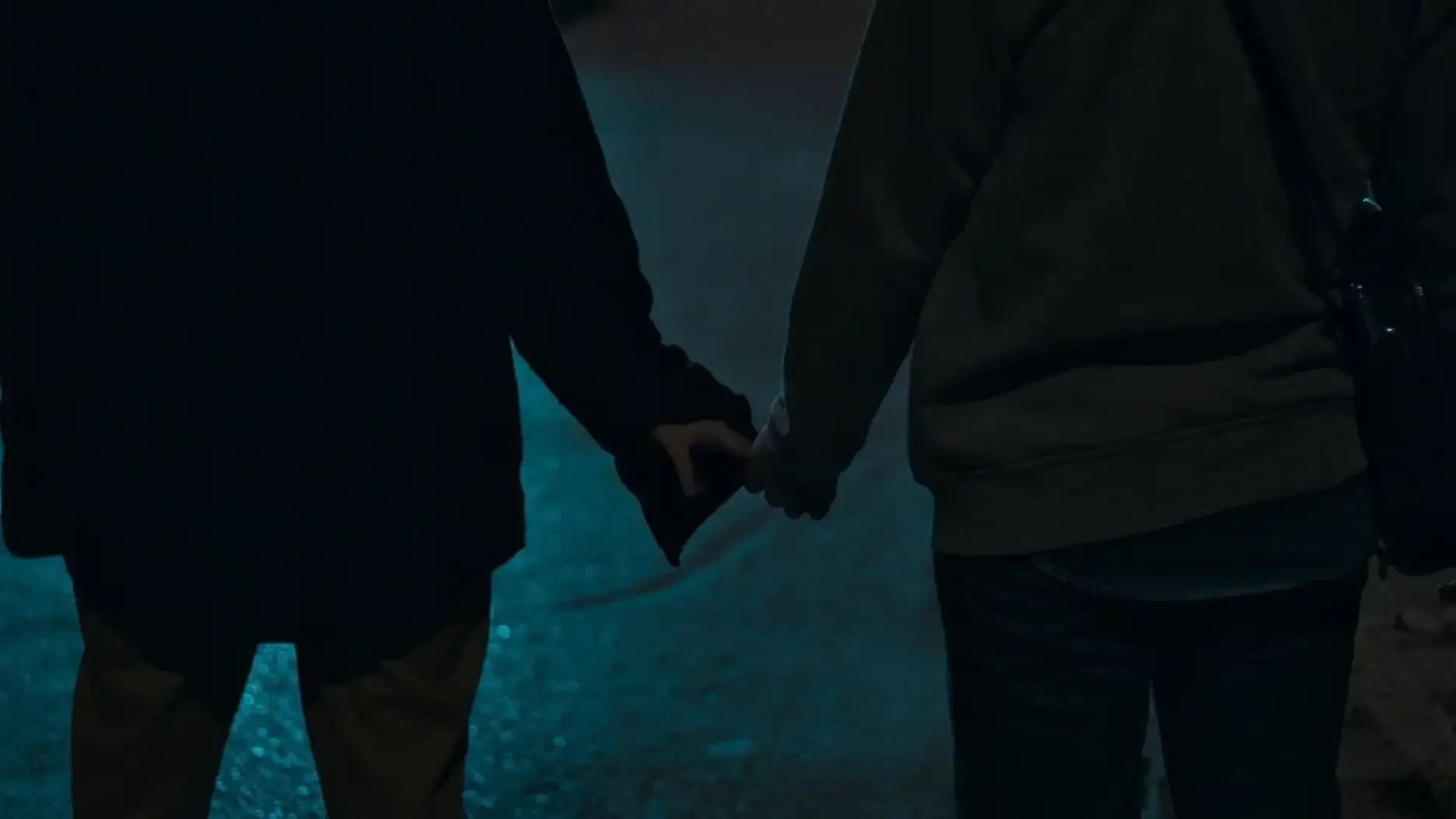 two people hold hands