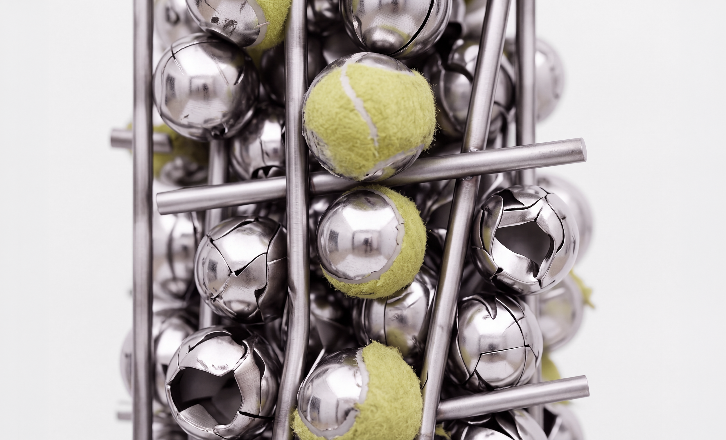   The Pressure Monument,  2026, Chrome-plated balls, tennis balls, welded stainless steel rebar, 34 × 14 × 11 inches 