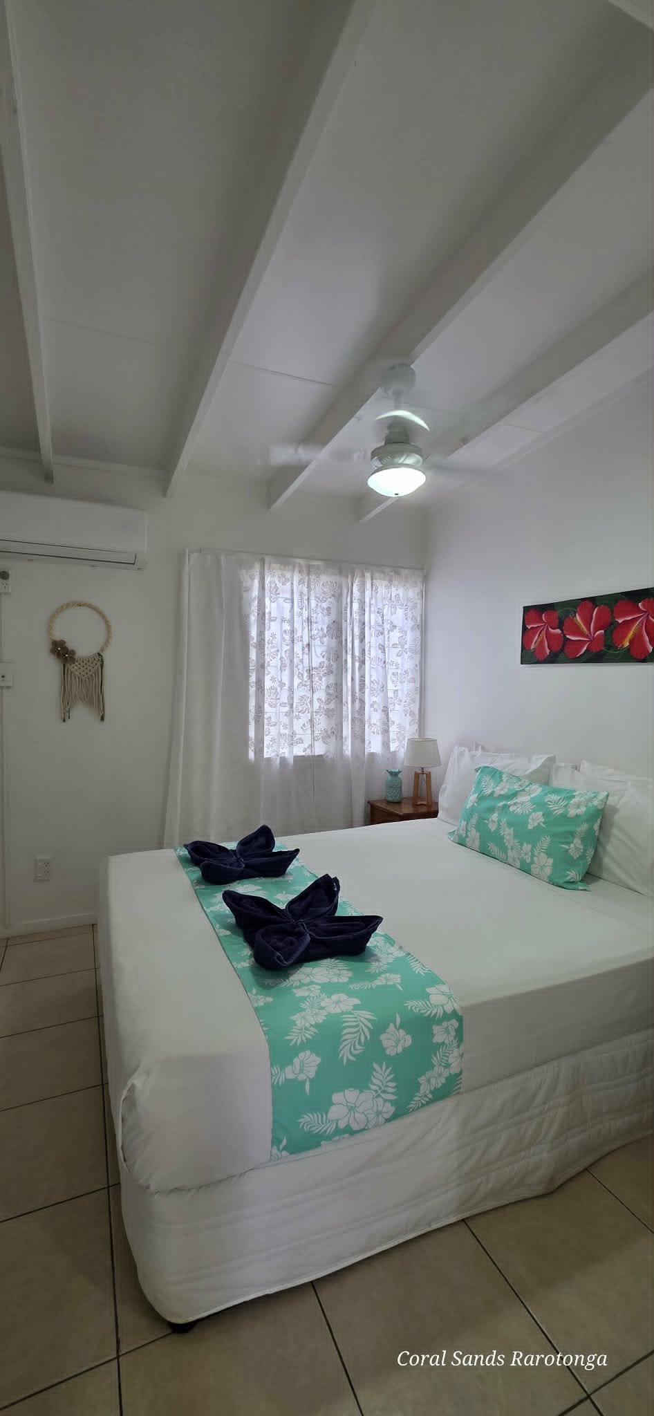 Bedroom in the One Bedroom Garden Apartment at Coral Sands Apartments in Arorangi, Rarotonga, featuring a queen bed, tropical décor, air conditioning and a peaceful garden setting.