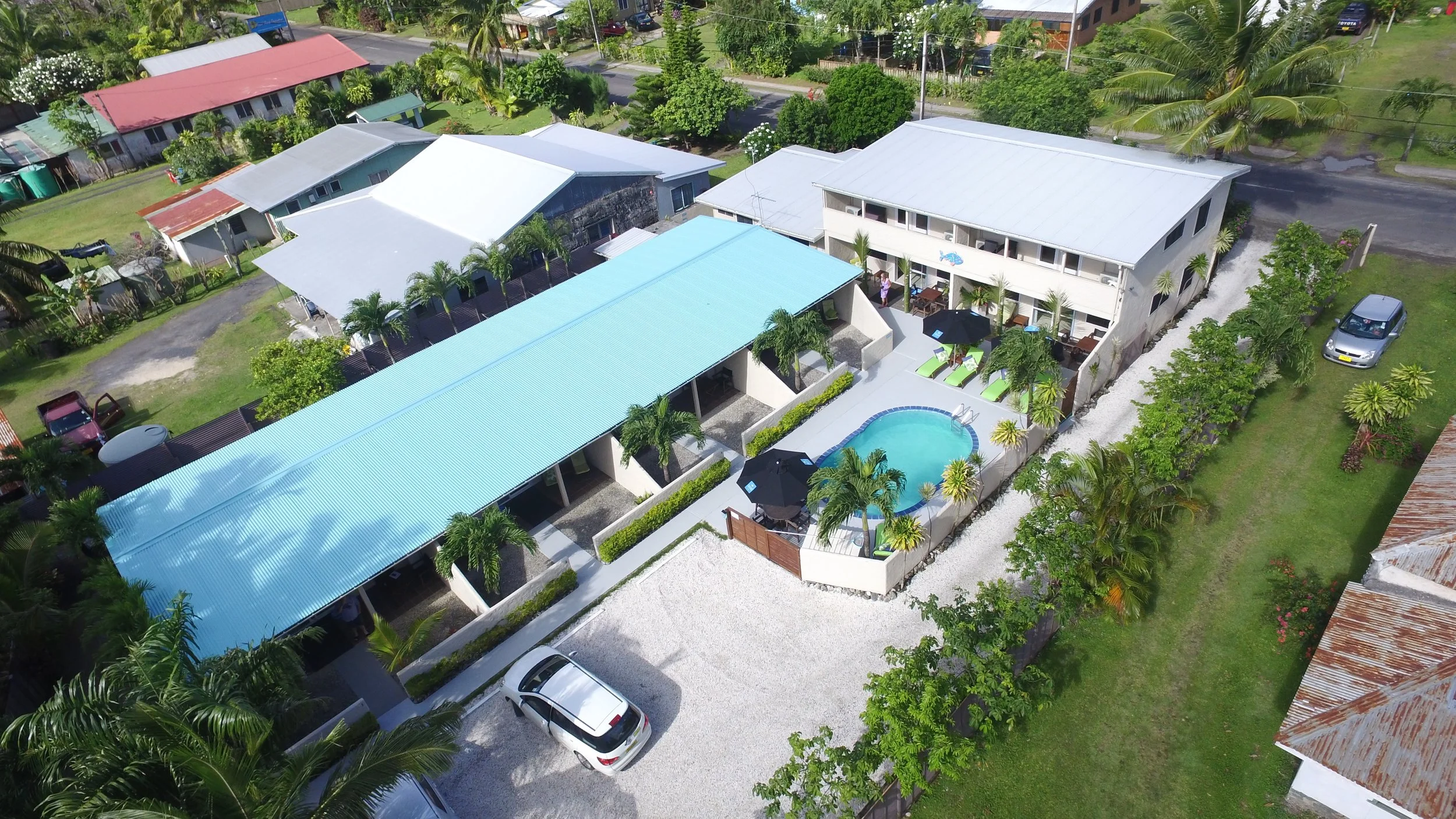 Aerial view of Coral Sands Apartments in Arorangi, Rarotonga, featuring the swimming pool, tropical gardens and self-contained accommodation close to the beach.