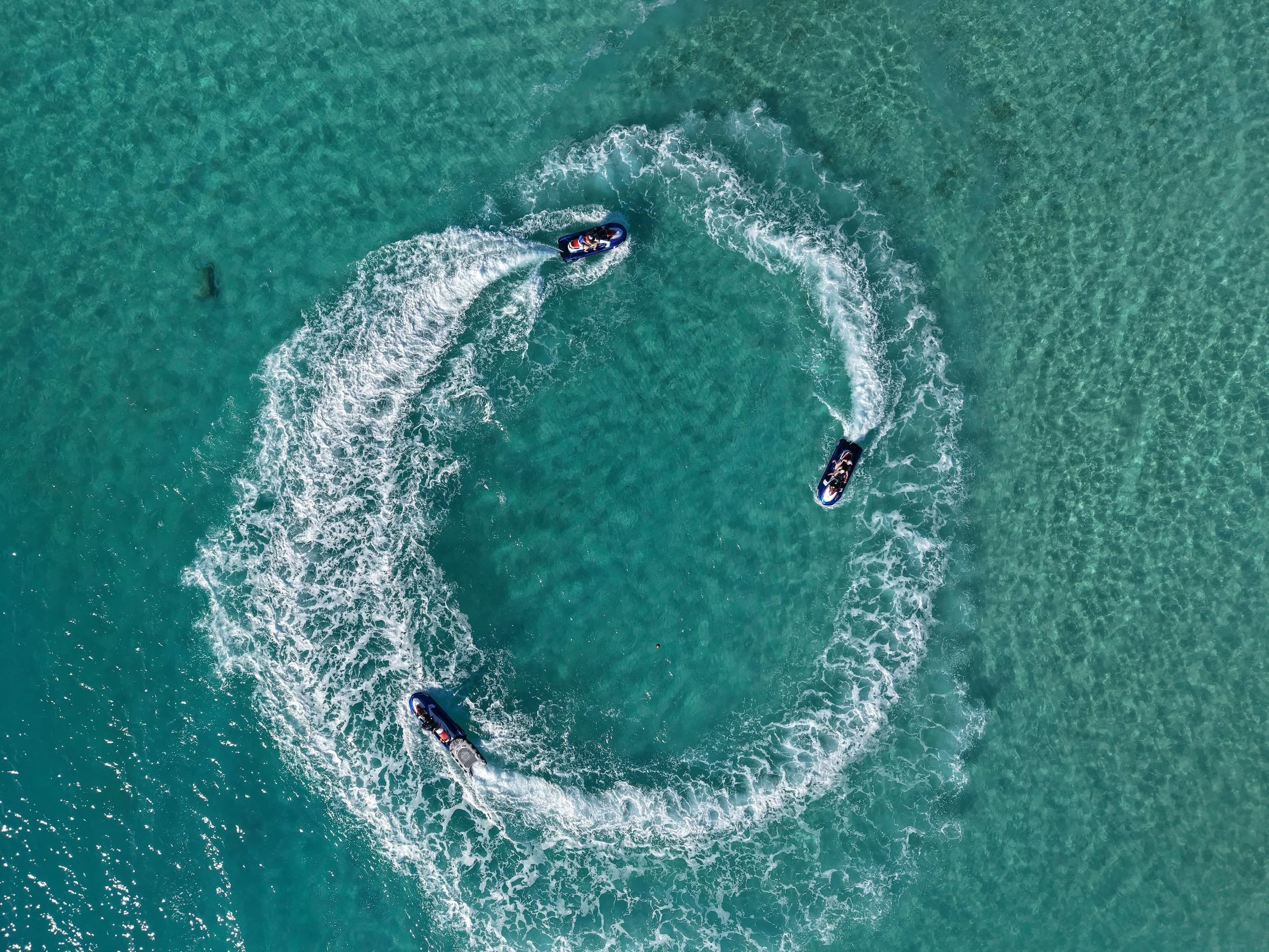 Visitors exploring the coastline of Rarotonga on a TVK Water Sports jet ski tour.