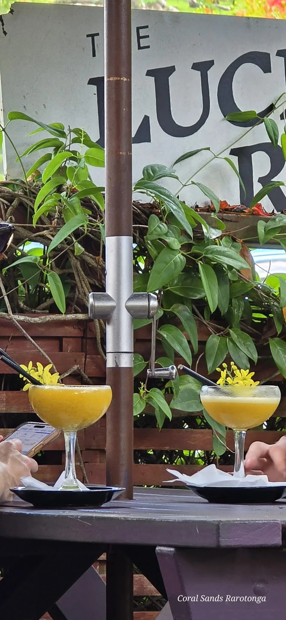 Cocktails at Lucky Rooster Eatery in Rarotonga. Relax with handcrafted tropical cocktails, delicious meals and a welcoming island atmosphere—another great dining option close to Coral Sands Apartments.