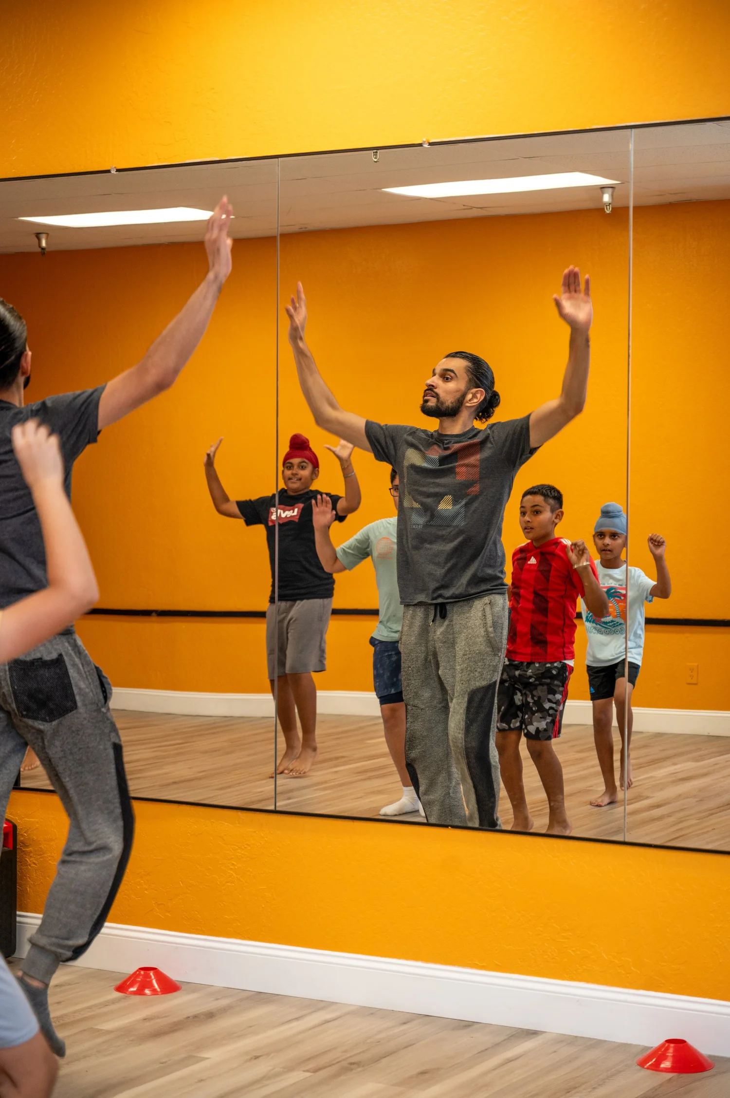 An instructor demonstrating Bhangra movements with students
