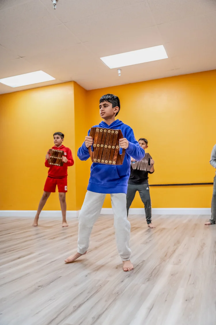 Young dancers practicing Bhangra in the academy studio
