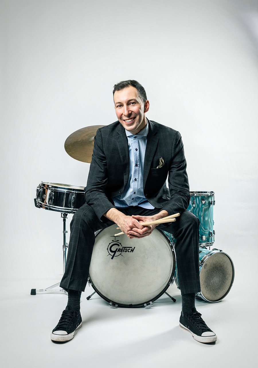 Portrait of Kelby MacNayr sitting on a drum