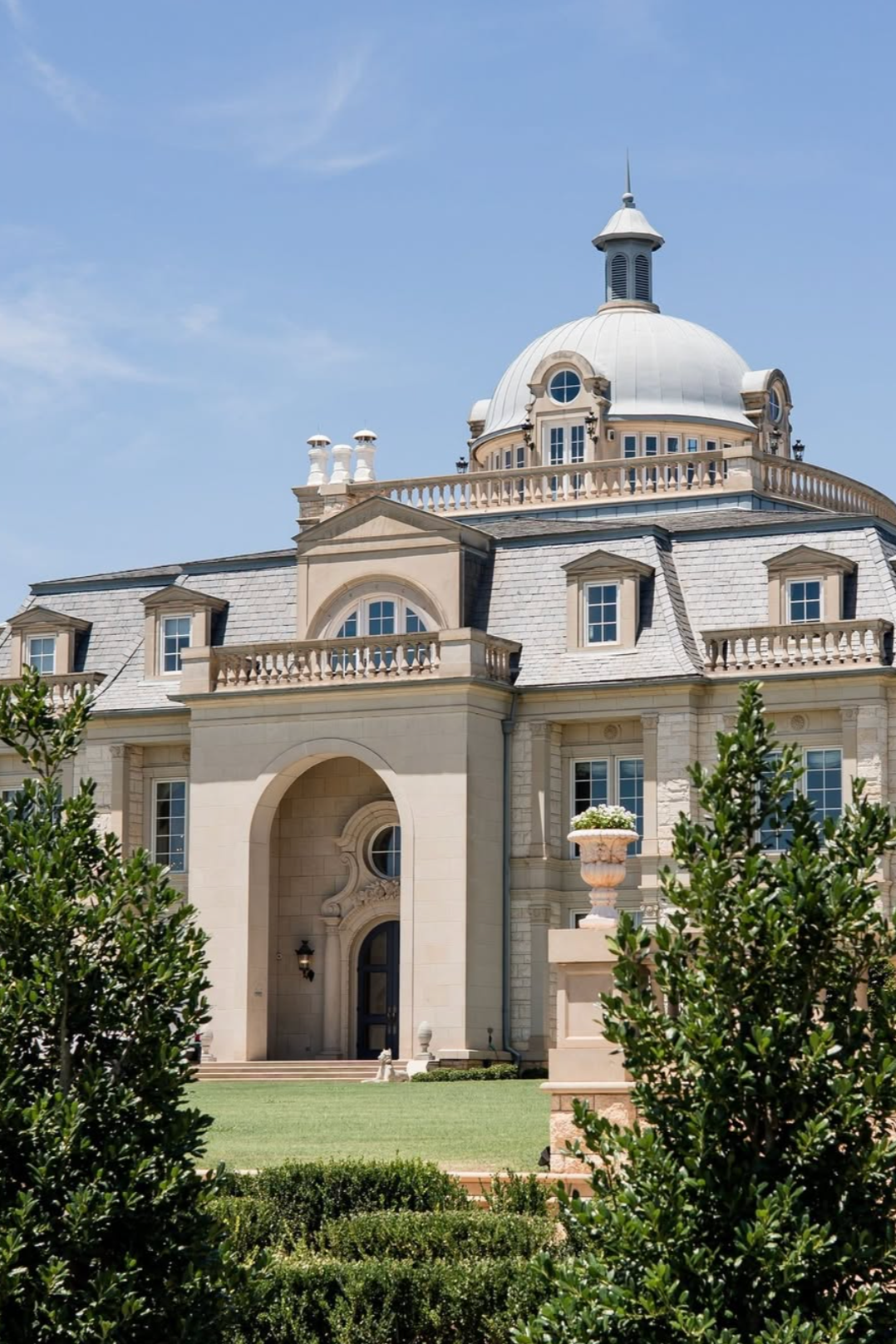 The Olana A large, elegant mansion with a domed roof, arched windows, and classical architectural details, surrounded by greenery and a well-manicured lawn.