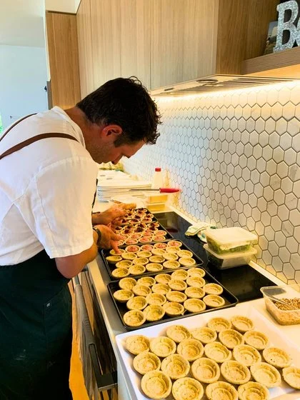 Birchwood chef Kane preparing canapés in a client's home kitchen, private chef catering in Jindabyne