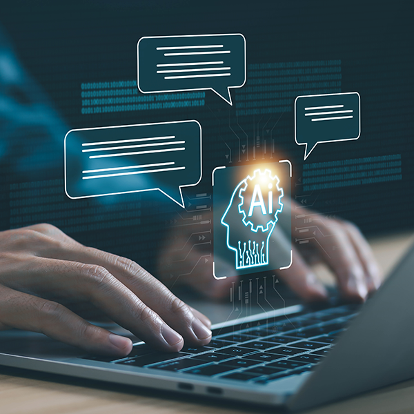 Hands typing on a laptop keyboard with digital AI and chat bubble graphics overlayed.