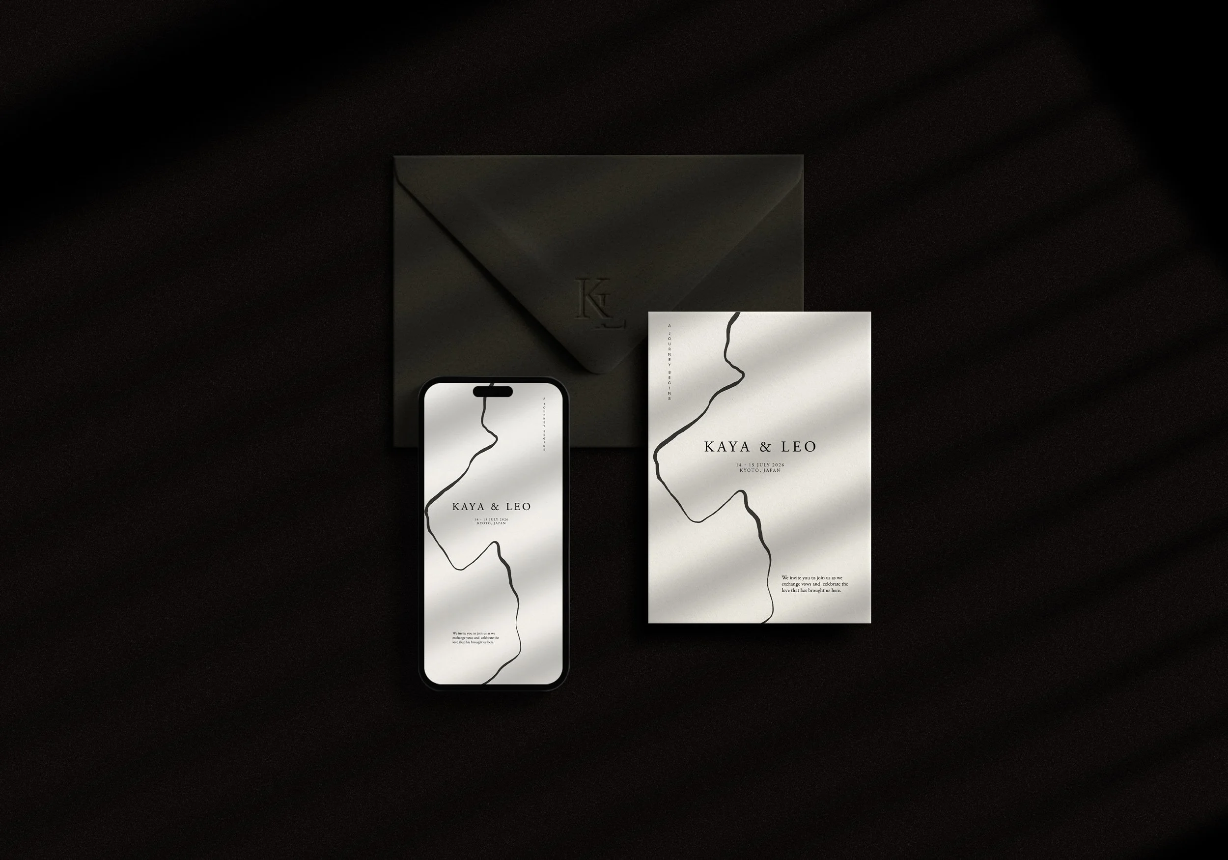 Wedding invitation set including a black envelope, a white invitation card with black calligraphy, and a smartphone displaying the same invitation design, all placed on a dark surface with shadows.