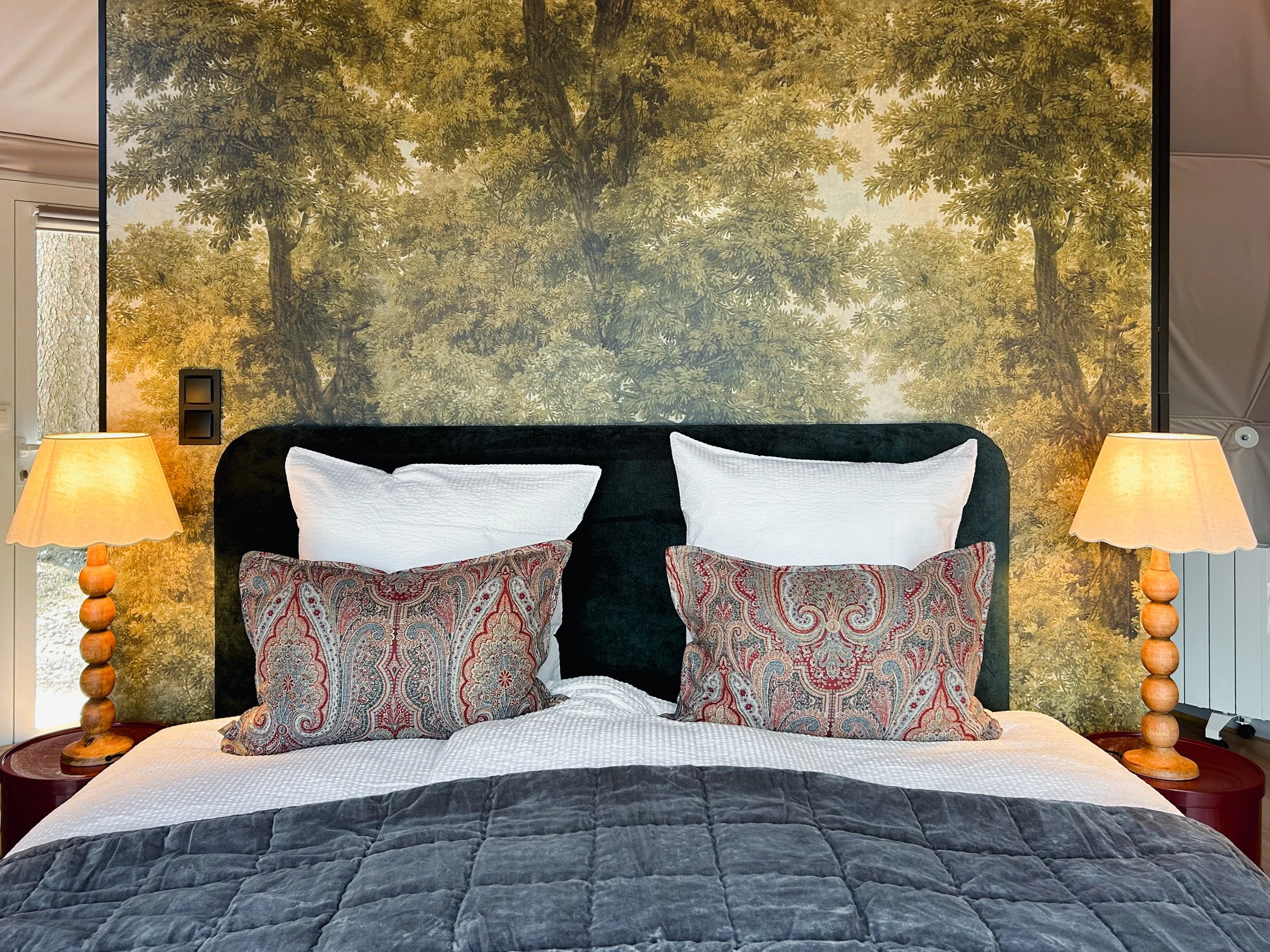 Cosy bed inside a luxury glamping dome in the Ardennes