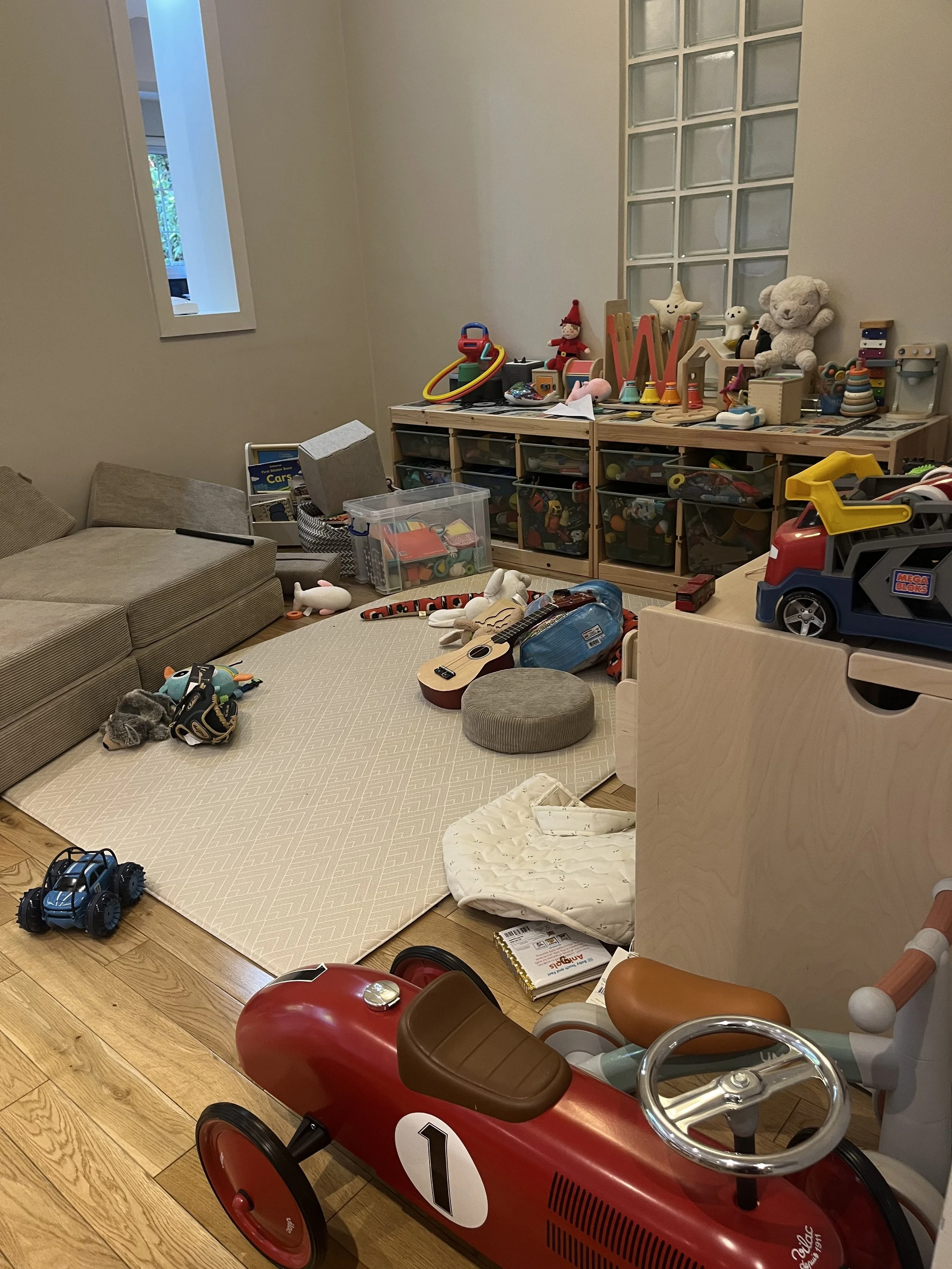 Playroom filled with numerous toys and play materials, illustrating how an overwhelming environment can make focused, purposeful play more difficult for children.