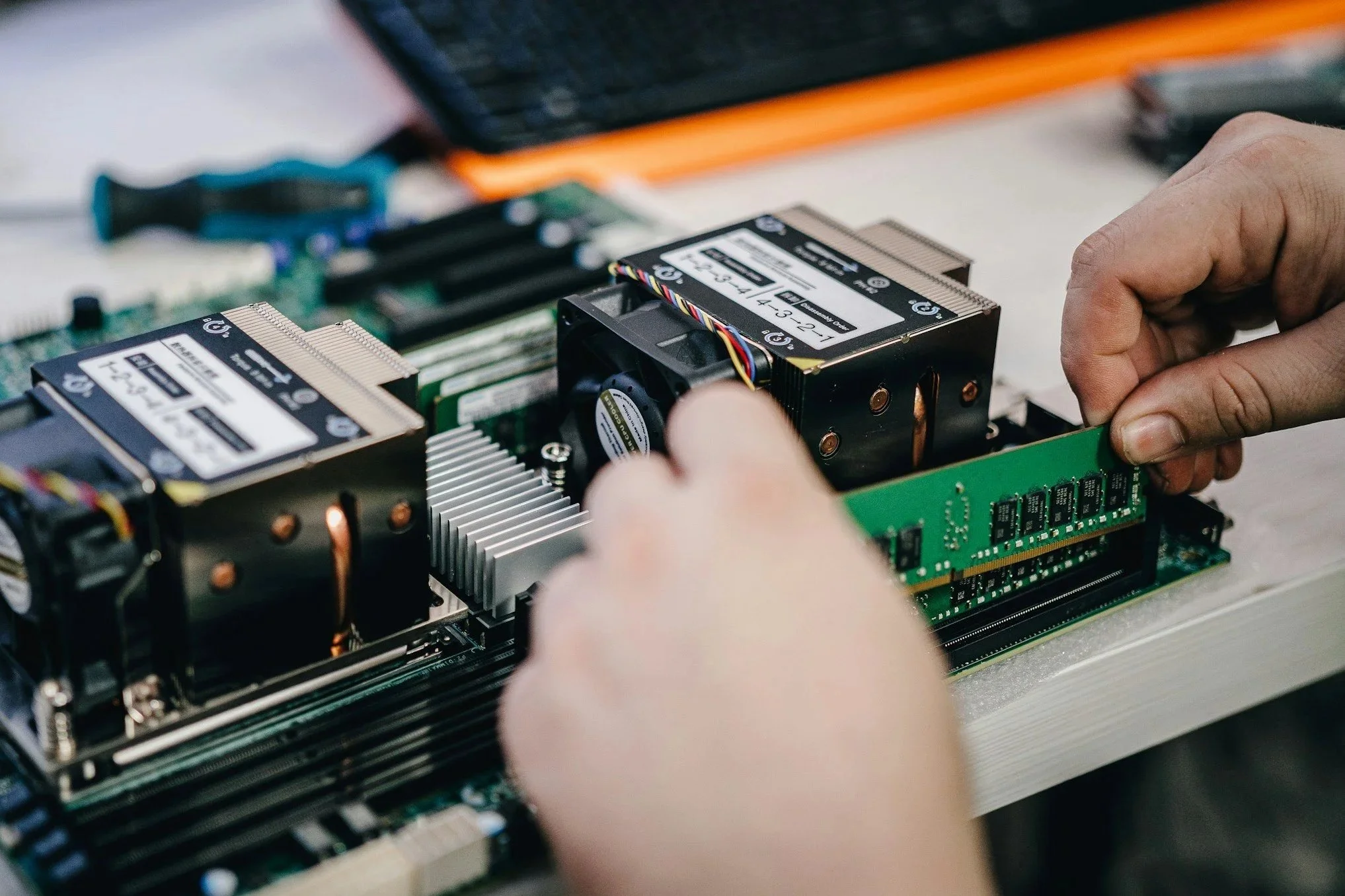 Two hands repairing a computer