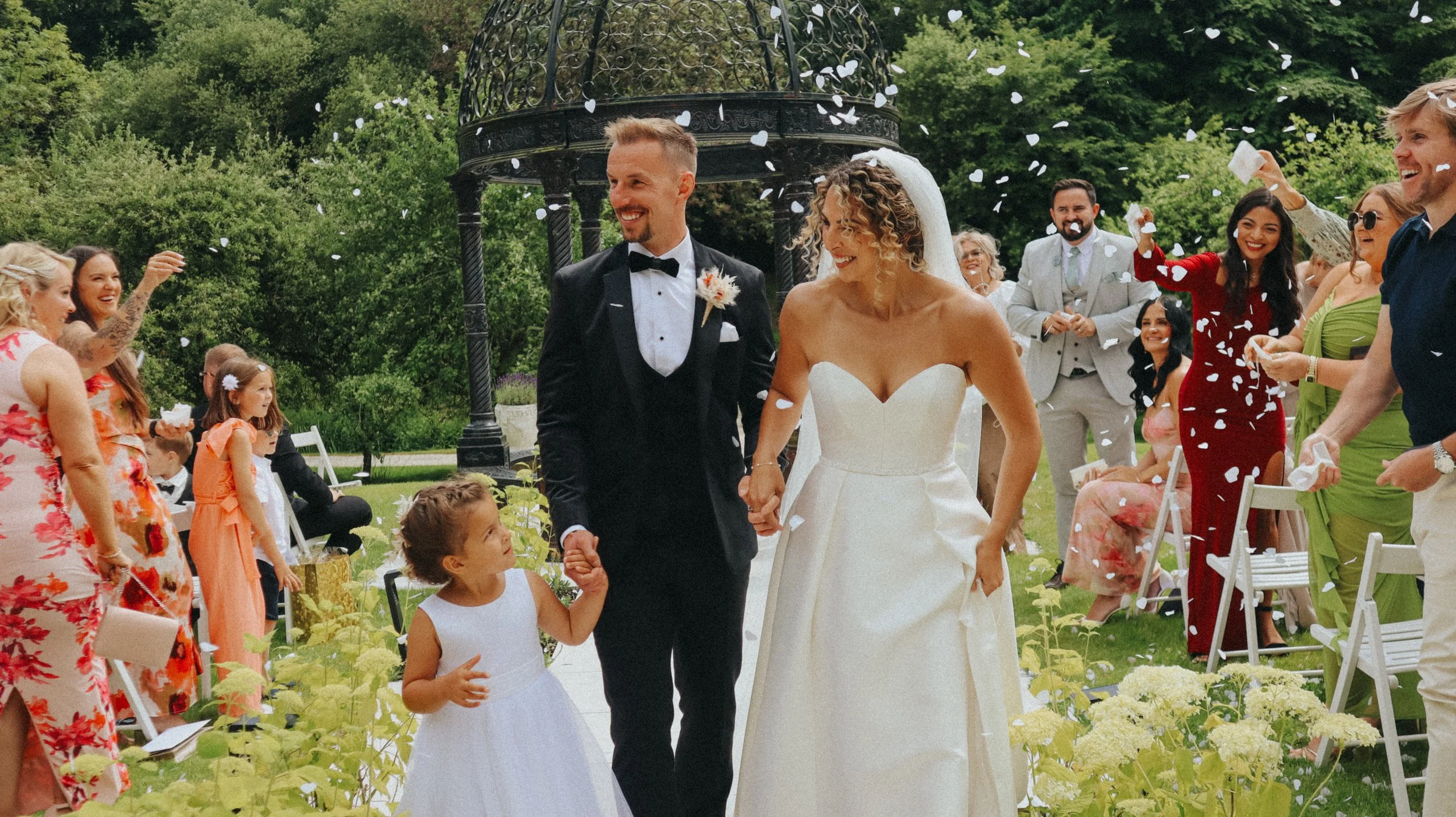 A couple in Ballymagarvey Village county Meath, Ireland. Standing with the train of her dress laid out in the gorgeous stone courtyard.
