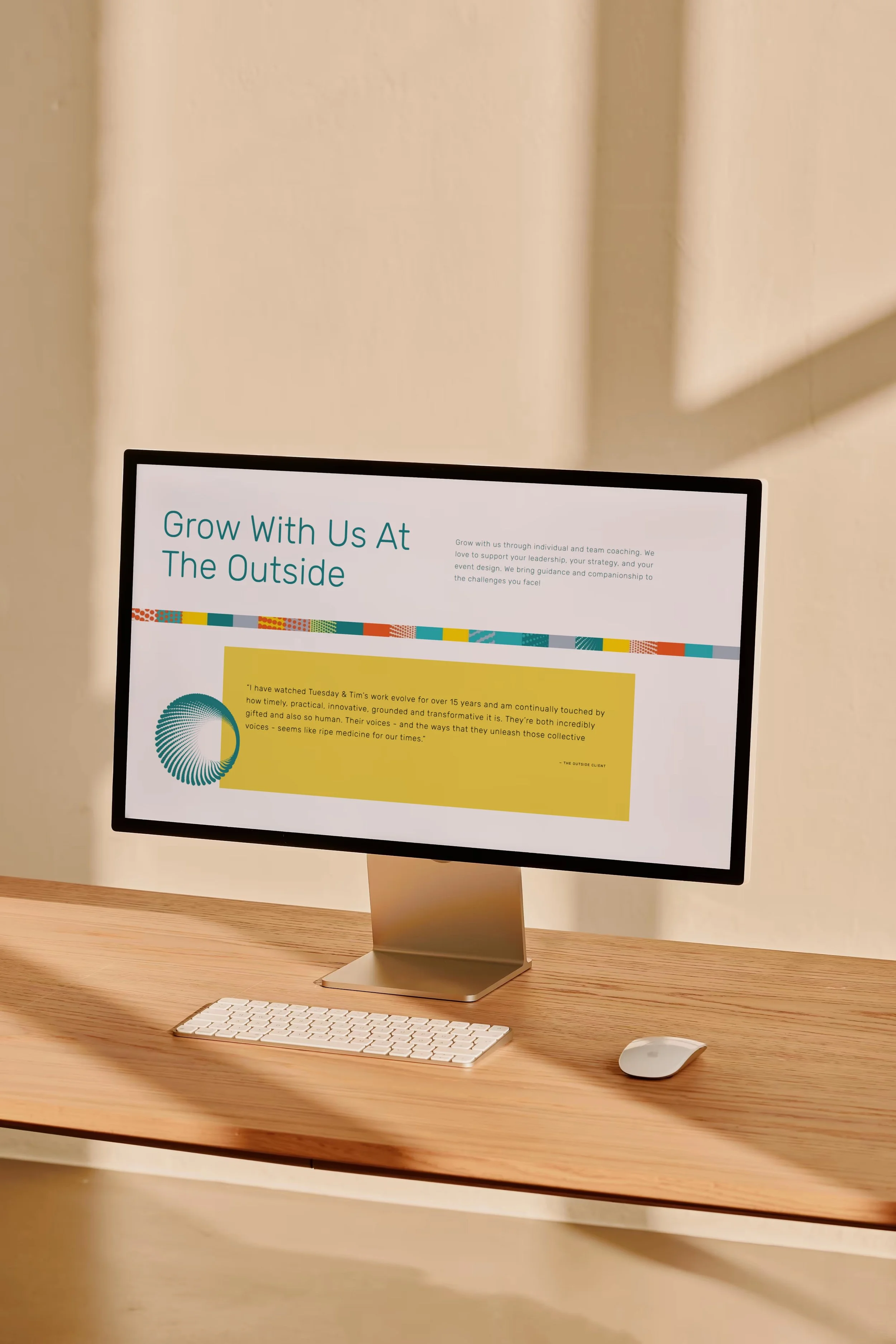A computer monitor on a wooden desk displaying a webpage with the title 'Grow With Us At The Outside' and a paragraph of text, accompanied by an illustration. It's a mock-up of a website designed by Lemonade Co.