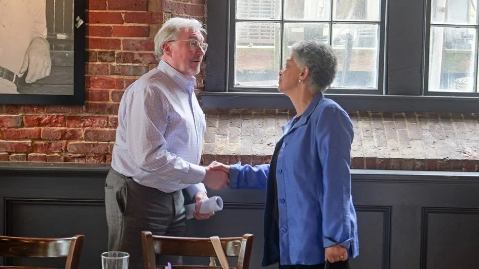 Boston Fed President and CEO Susan M. Collins speaking with SEDC Executive Director Dennis McCann after a roundtable at Cocheco Mills in Dover, New Hampshire.