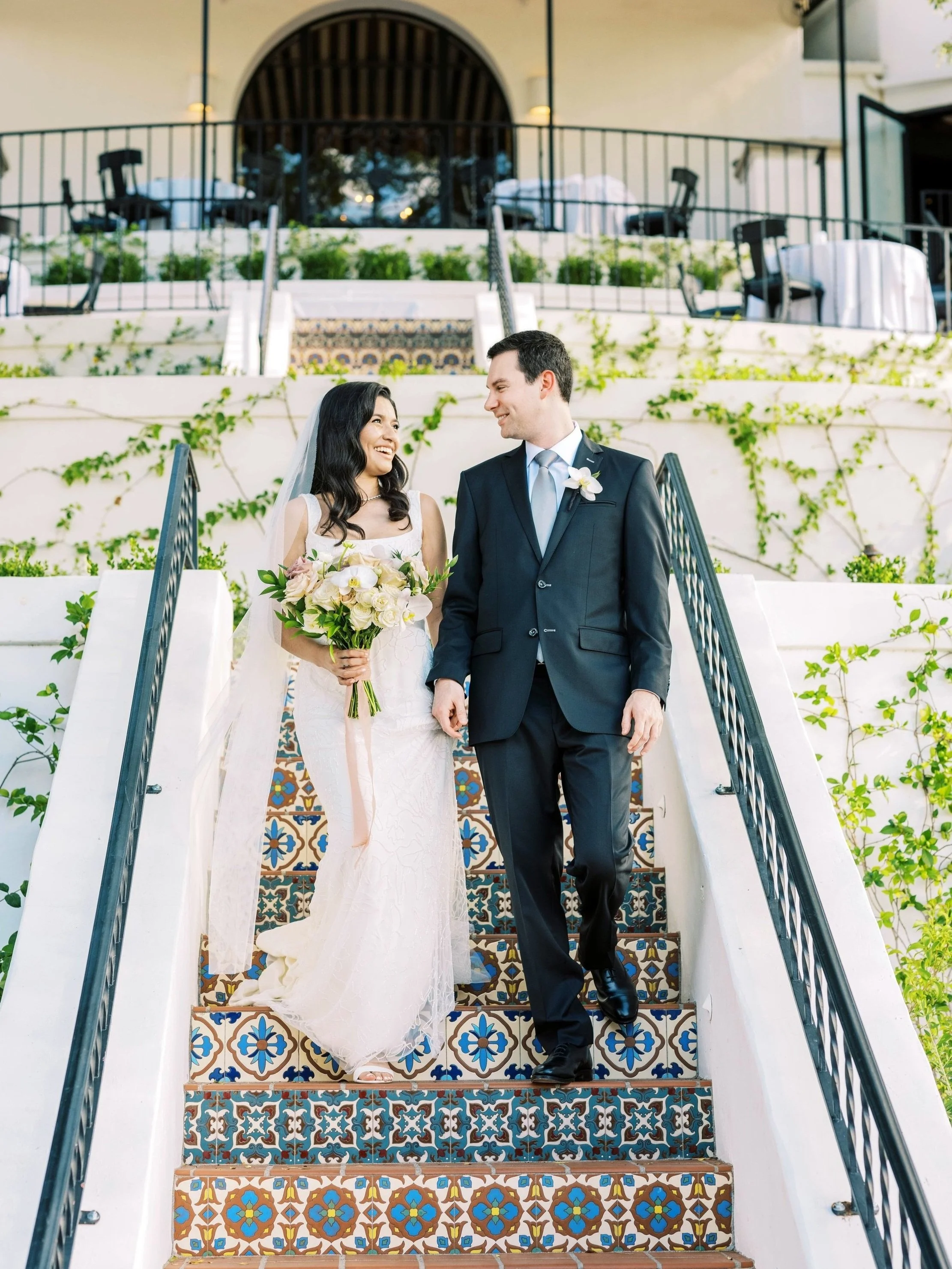 A wedding couple walking through Wrigley Mansion