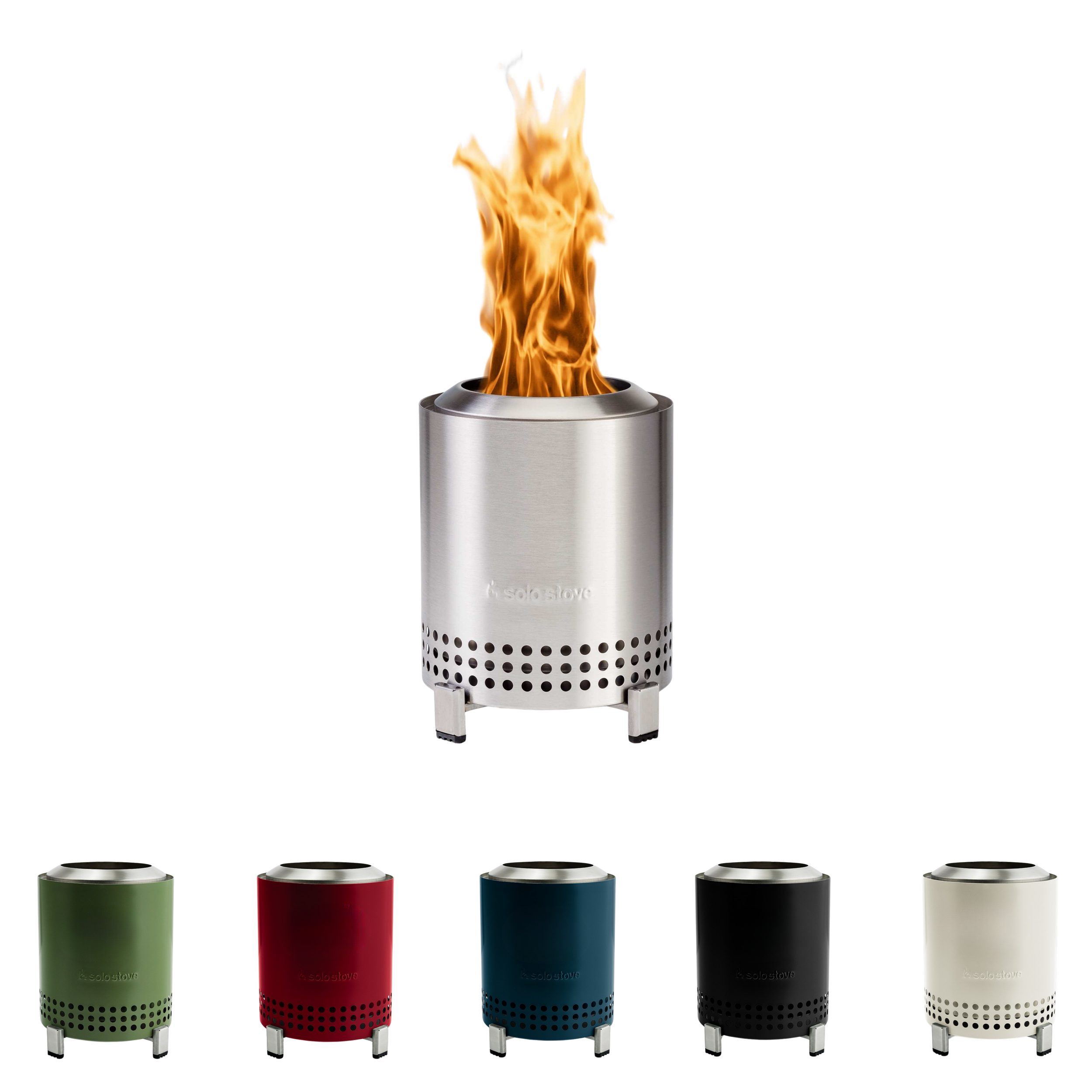 A portable stainless steel gas stove with flame and four empty cans in different colors (green, red, blue, gray) placed in front of it.