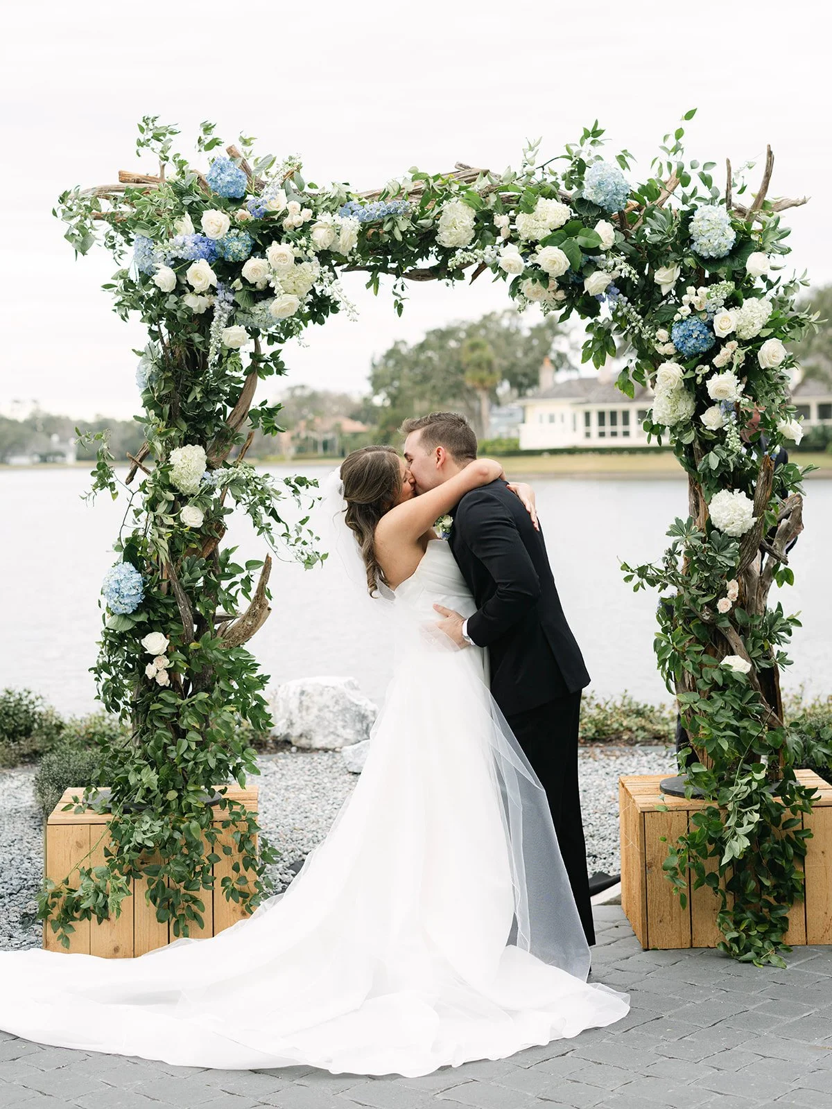 BrideAndGroomKissingAtArch_A&A.jpg