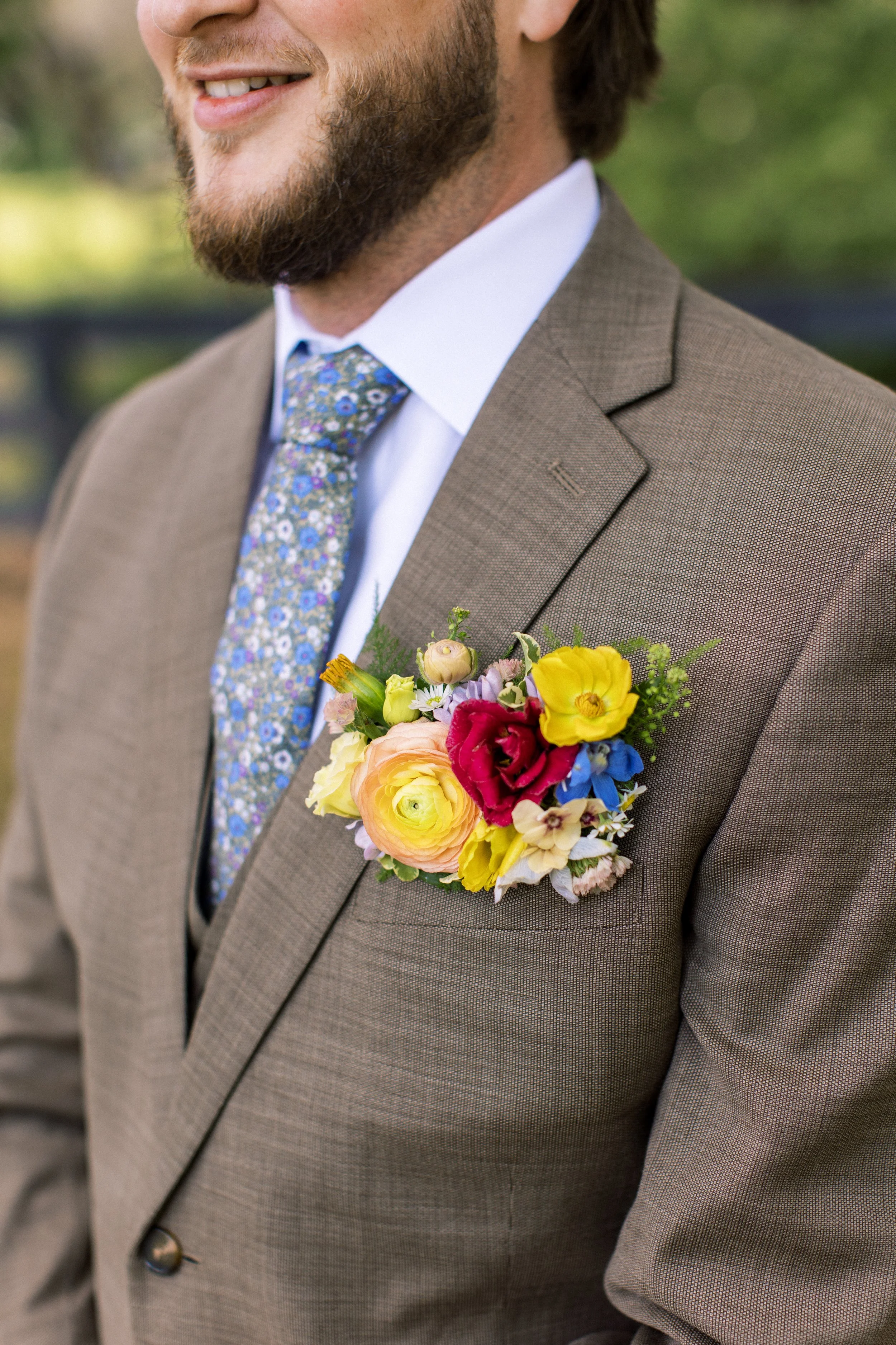 Close up of a floral pocket insert for groom instead of a boutonniere 