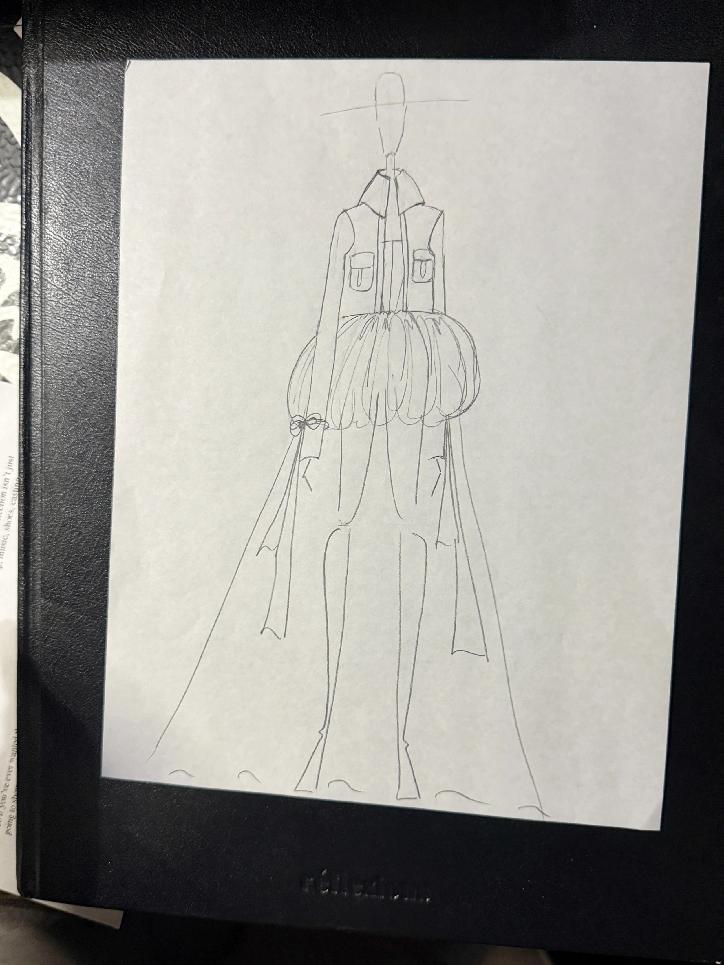 A hand-drawn sketch of a mannequin or fashion figure, with a detailed top, skirt, and high heels, seen from the front.