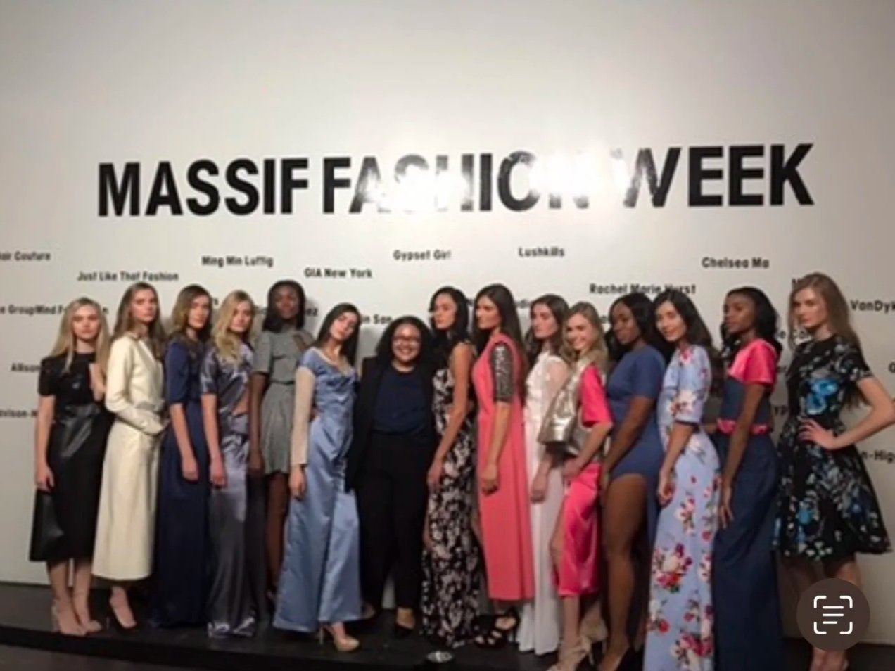 Group of models standing in front of a wall with 'Massive Fashion Week' written on it.