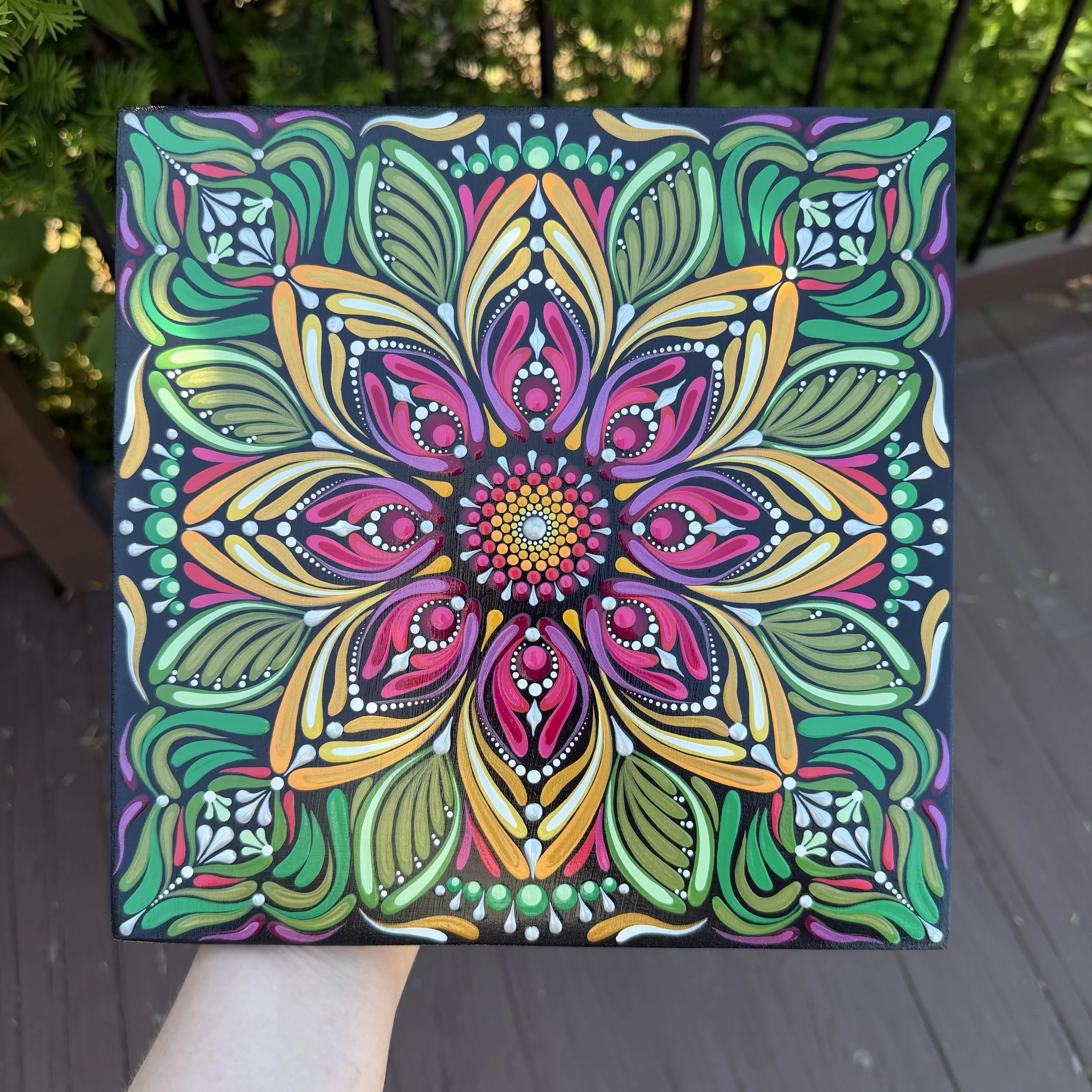 Colorful geometric and floral pattern on a rectangular black background, featuring pink, orange, yellow, green, blue, white, and purple designs.