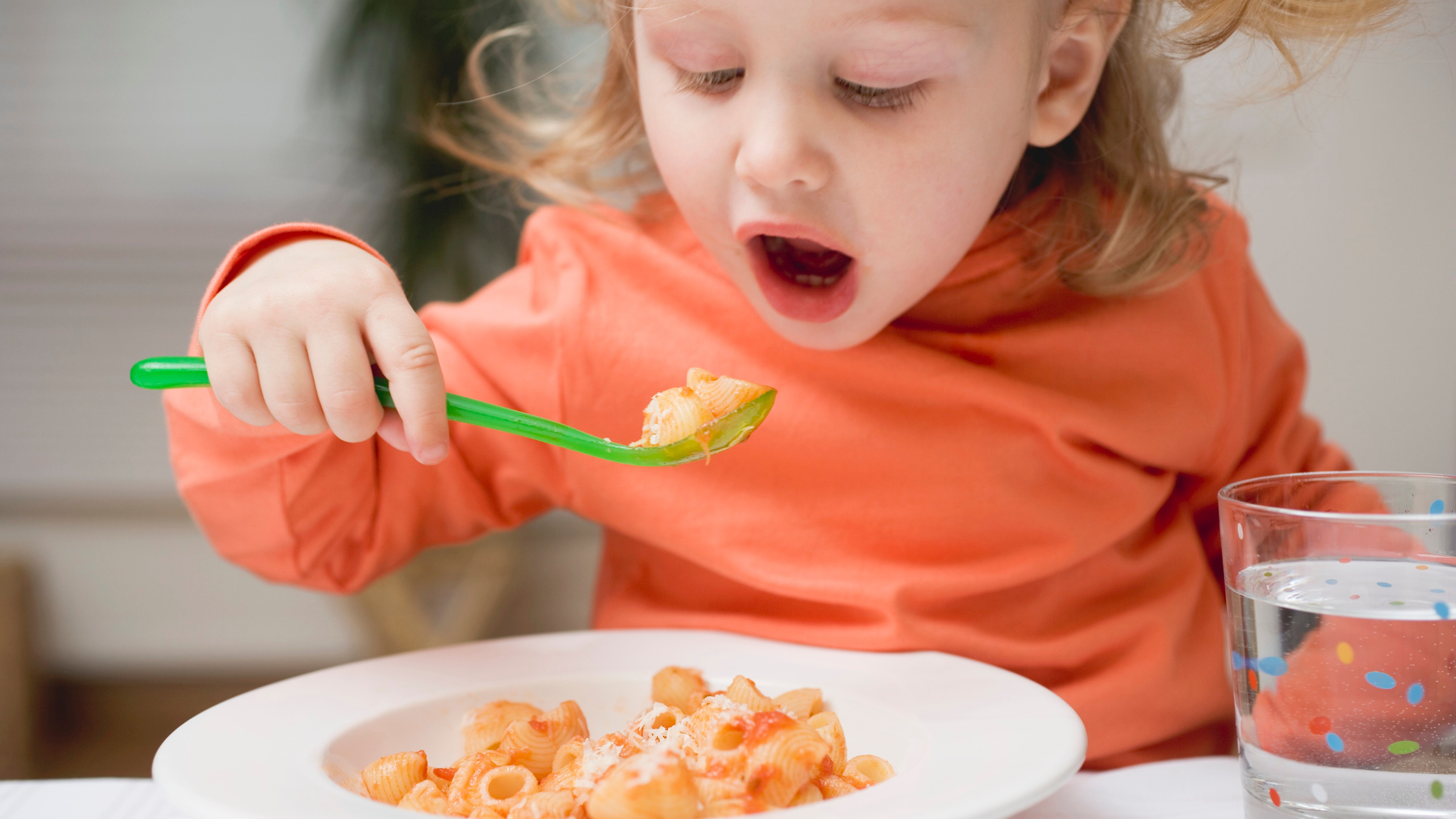 Kid eating food at the table